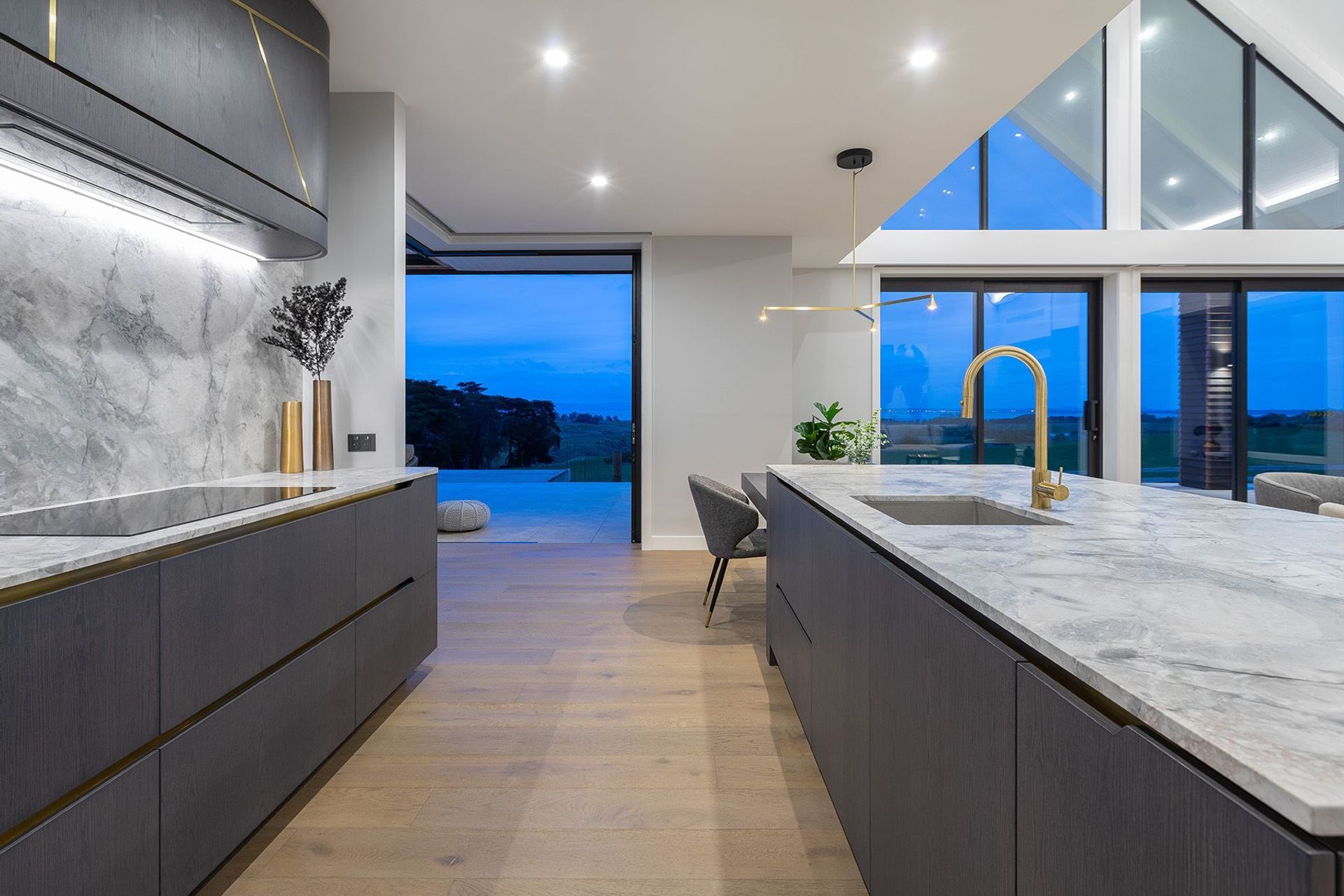 Kitchen design by Cube Dentro, Calcutta marble with brushed brass PVD Oli 316 tapware