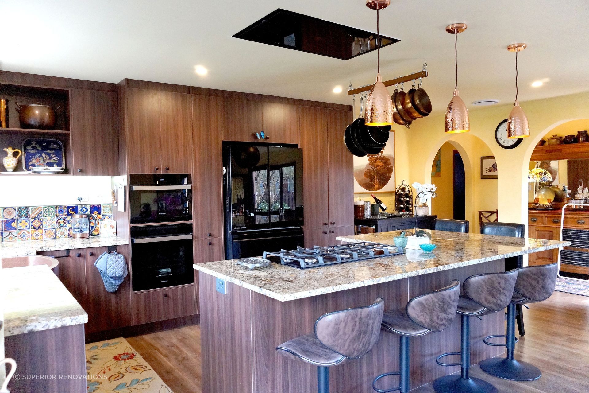 Kitchen renovation in Stanmore Bay: An island bar which doubles as a dining table and cooking bench.