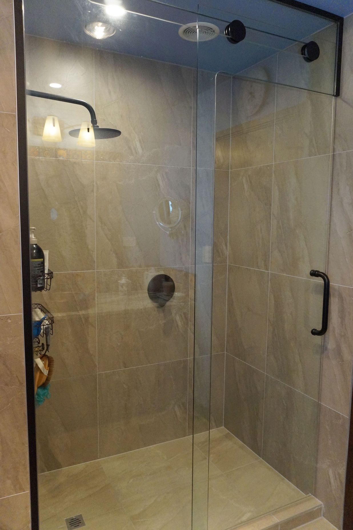 This tiled shower was renovated with a floor to ceiling glass door to make the bathroom look more open and spacious – Bathroom renovation in Stanmore Bay, Auckland