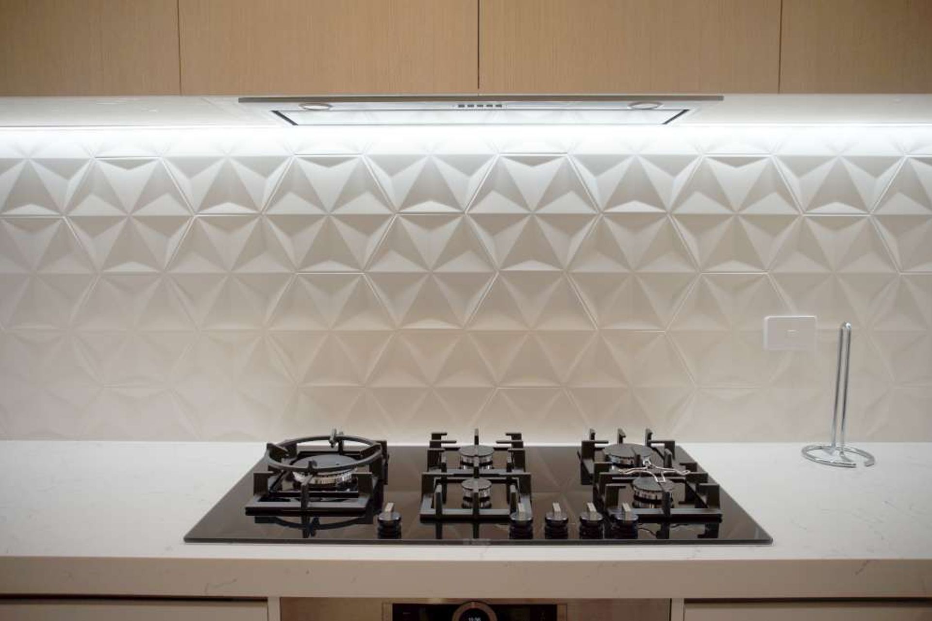 Kitchen renovation in Parnell: We added textured 3D tiles as a backsplash for this client to add character and interest in the kitchen wall.