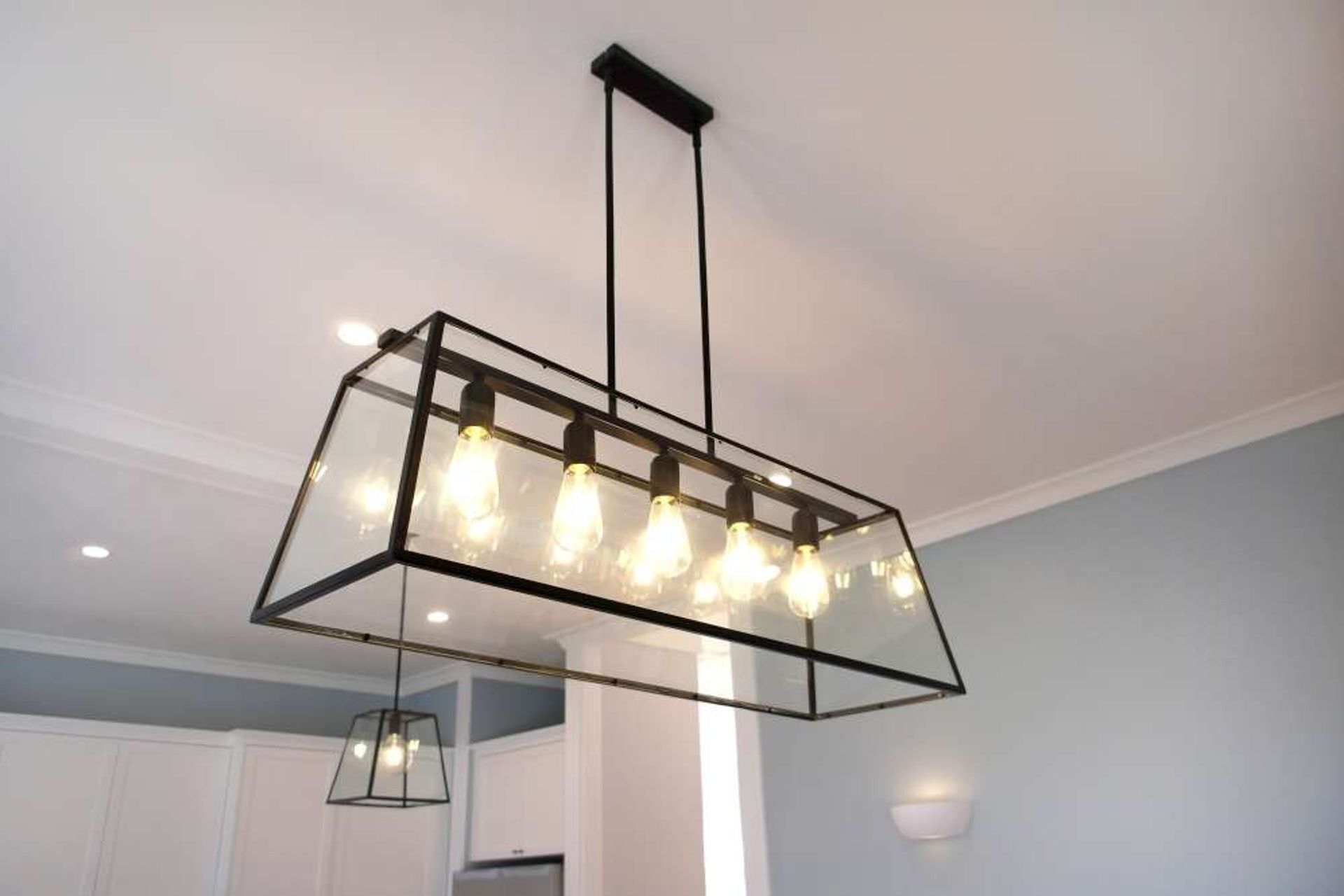 This long multi-bulb pendant light was installed above the dining table