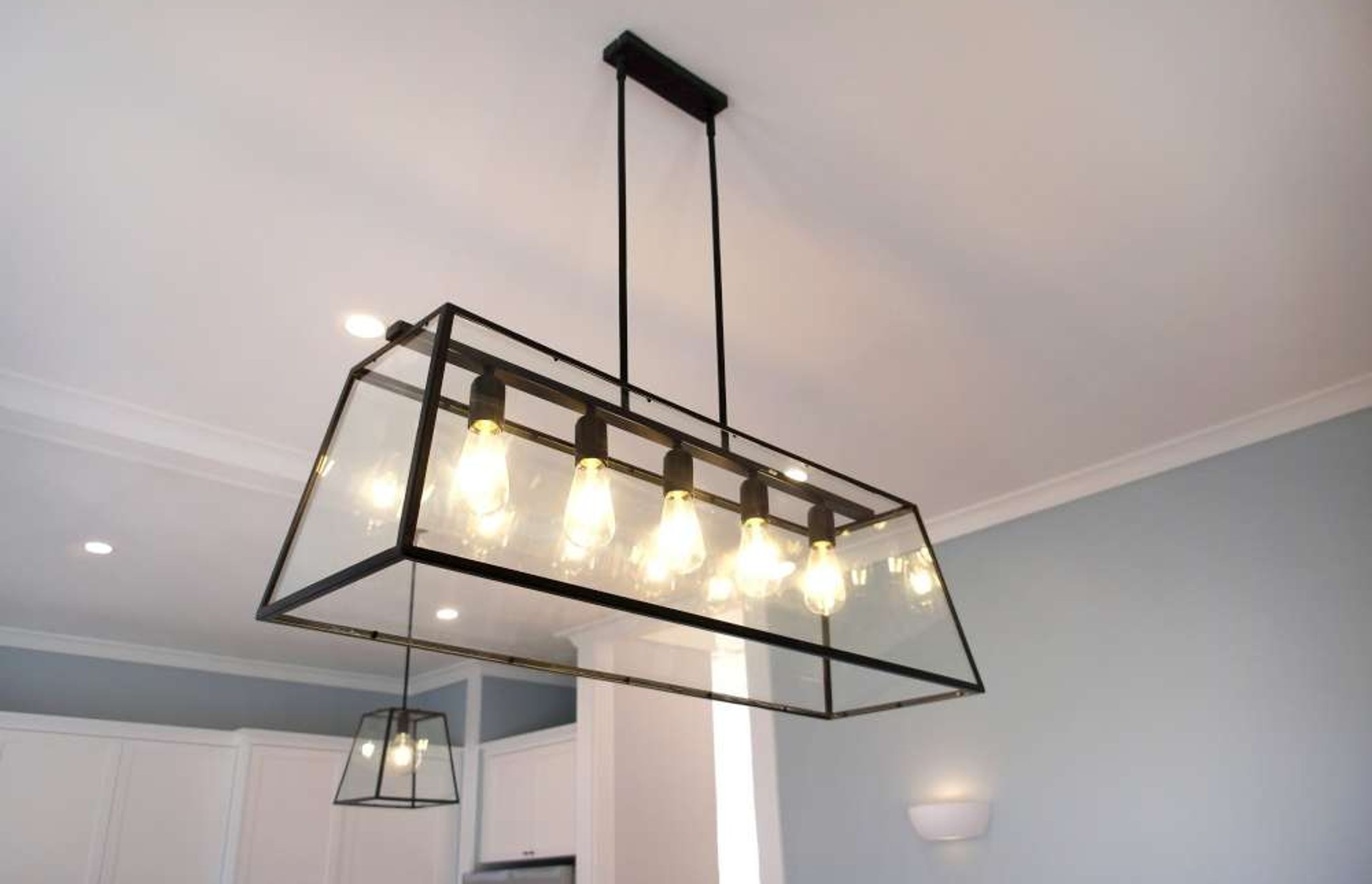 This long multi-bulb pendant light was installed above the dining table