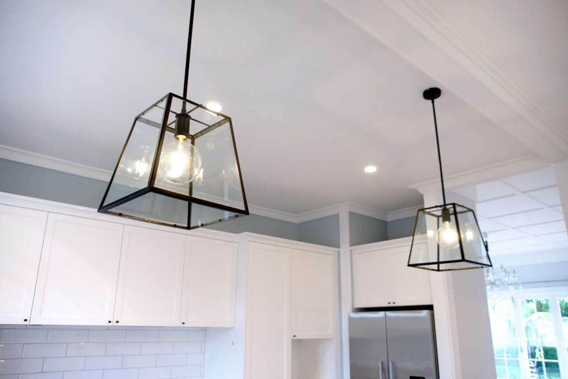 Two separate long pendant lights installed above the breakfast Island