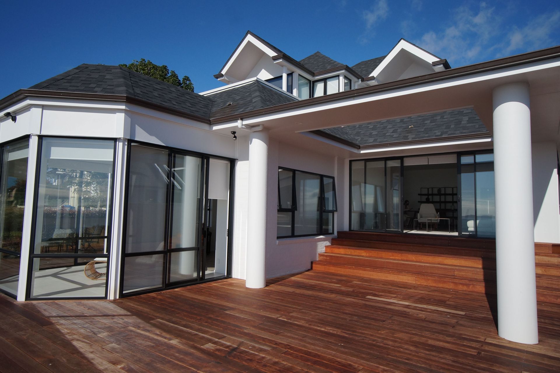 This elevation of the deck shows a beautiful Kwila Deck which contrasts beautifully with the off white walls, and columns of the house.