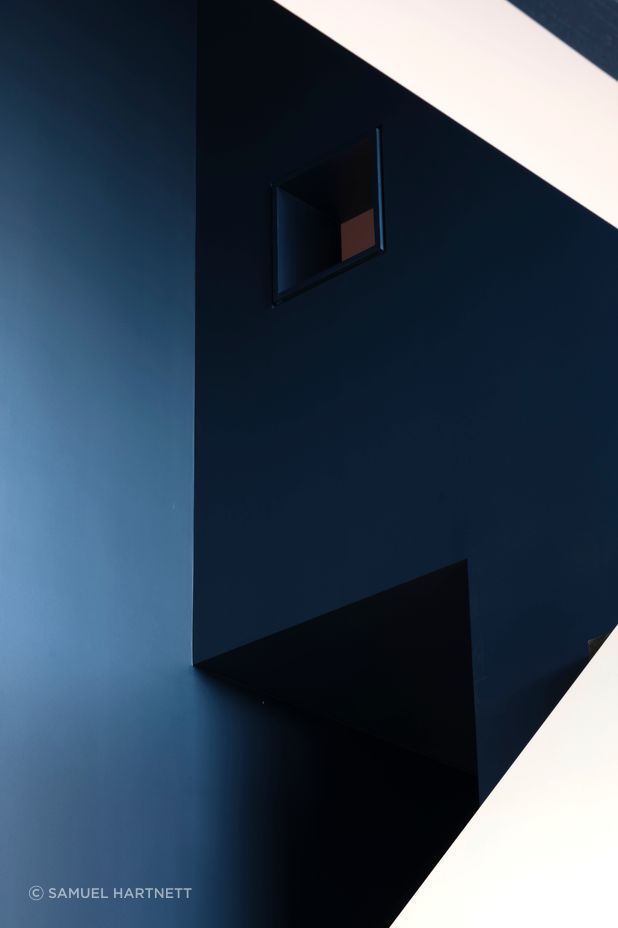 “In the kids’ bunkroom, there’s a ladder up to a third bunk that’s really super vertical. You have this tiny little window that looks back into the kitchen and living space, so you have these secretive, playful little moments,” says Dominic.