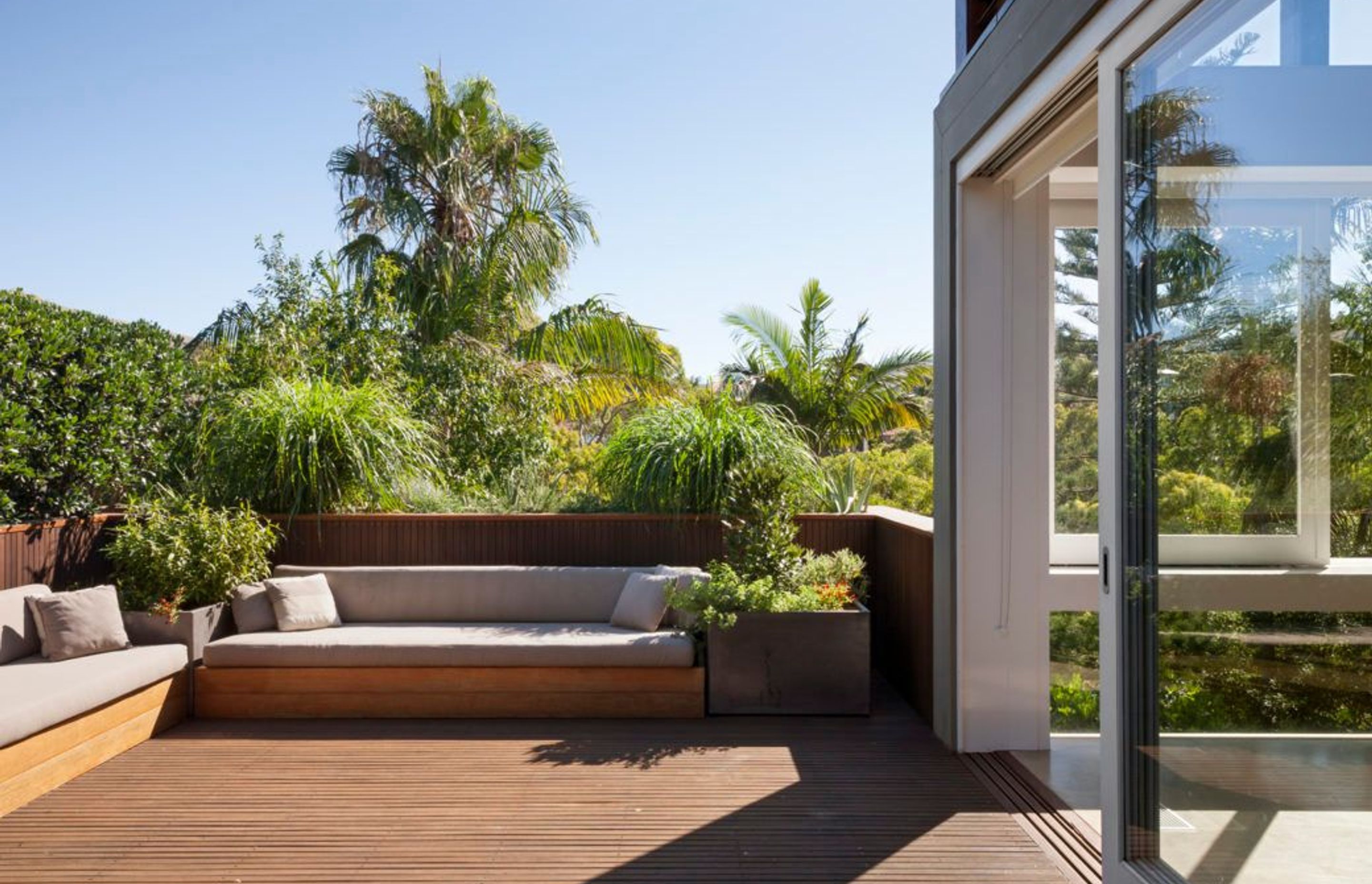 Large square lightweight pots on this balcony are filled with edible plants – the Parsley Bay garden – Pepo Botanic Design.