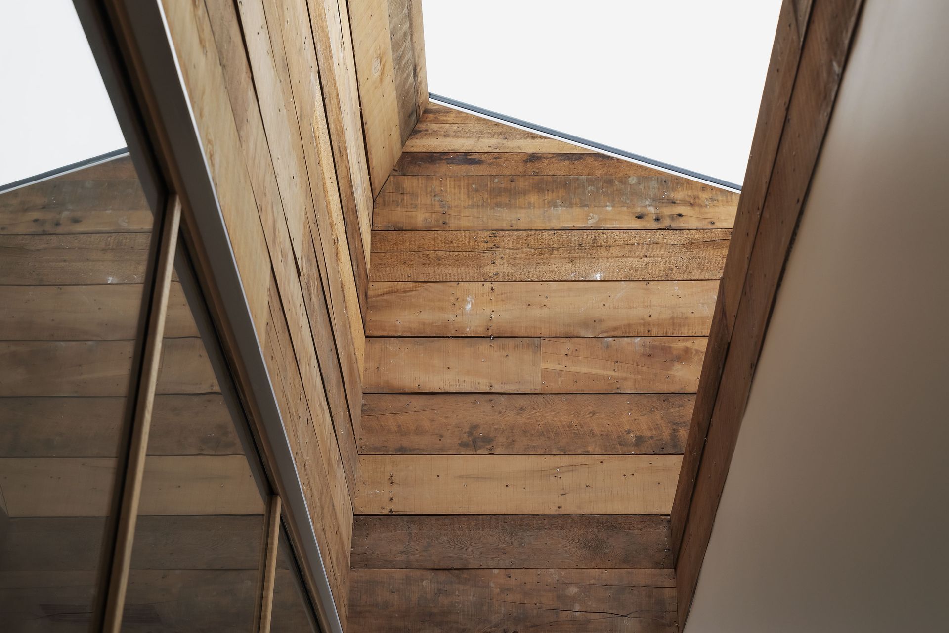 Kauri sarking rescued from an older part of the house clads the skylight shaft. Photo: David Straight