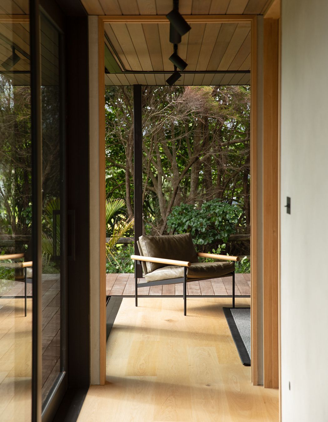 The guest room at the end of the bedroom spaces can be opened right up to the lush semi-tropical garden. Image credit: David Straight