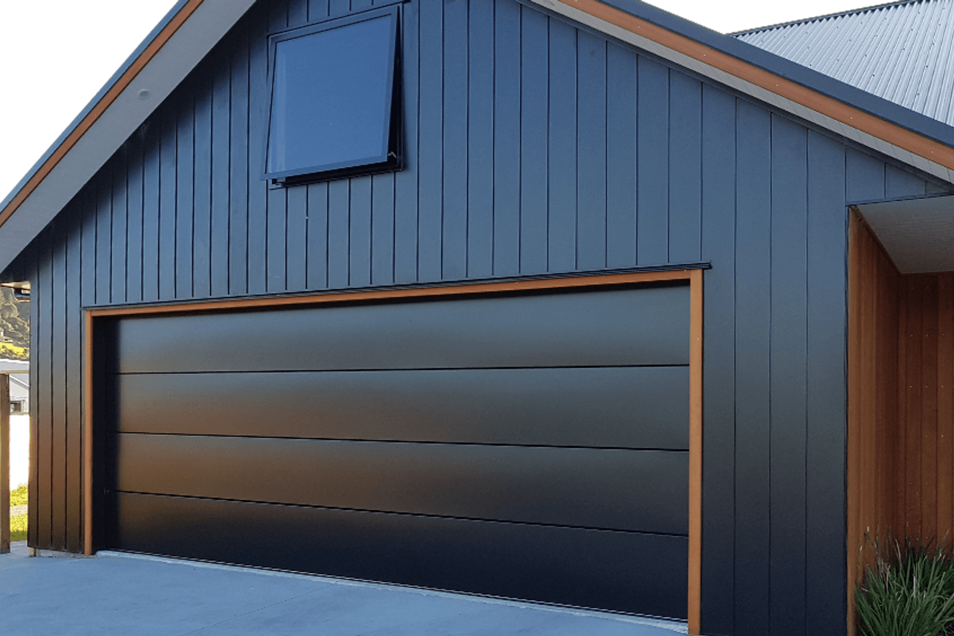 Dominator Nevada is a modern, minimalist steel sectional garage door with the added feature of negative detailing to produce bold horizontal lines that meet the demands of current home design trends.