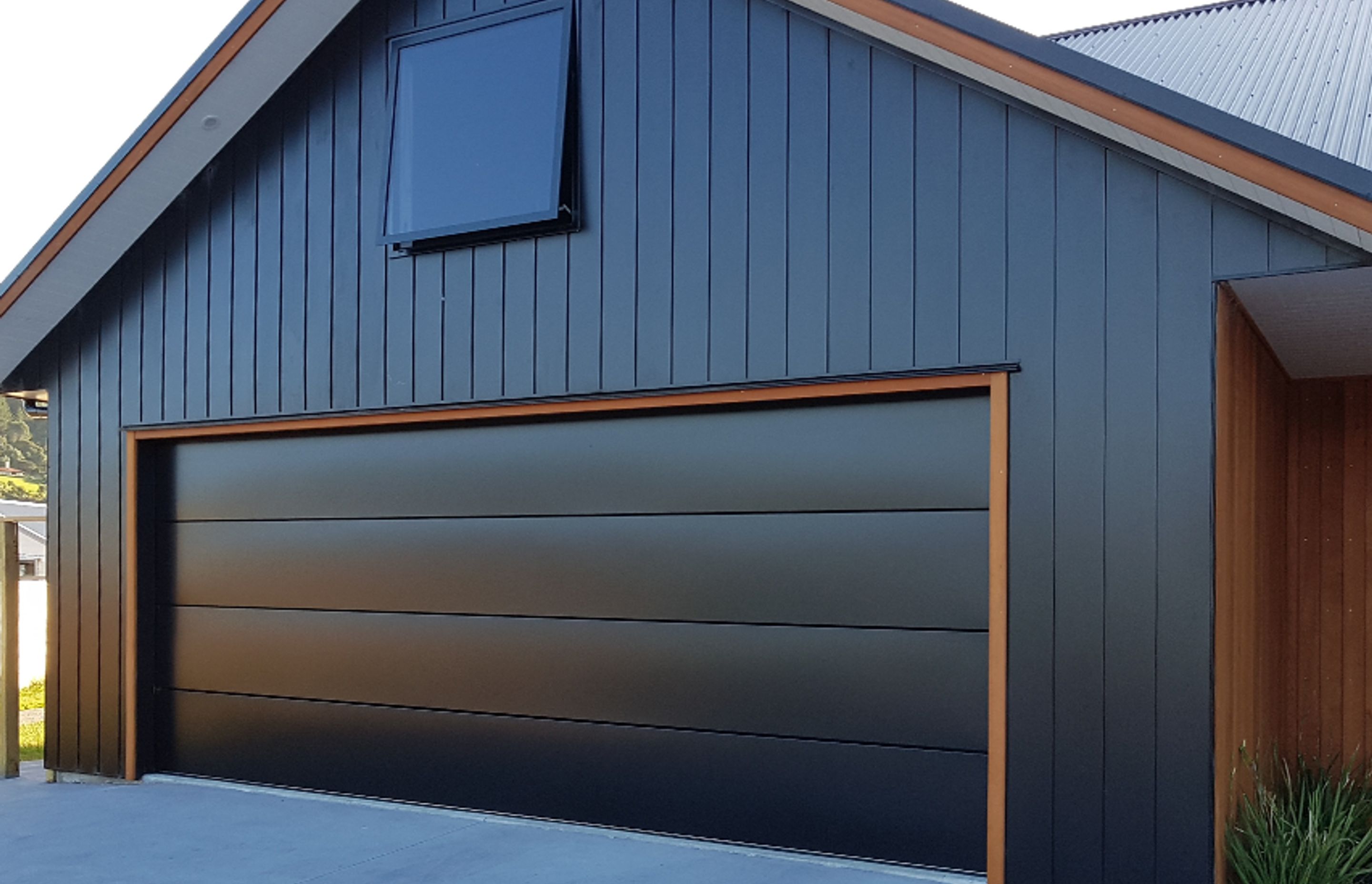 Dominator Nevada is a modern, minimalist steel sectional garage door with the added feature of negative detailing to produce bold horizontal lines that meet the demands of current home design trends.