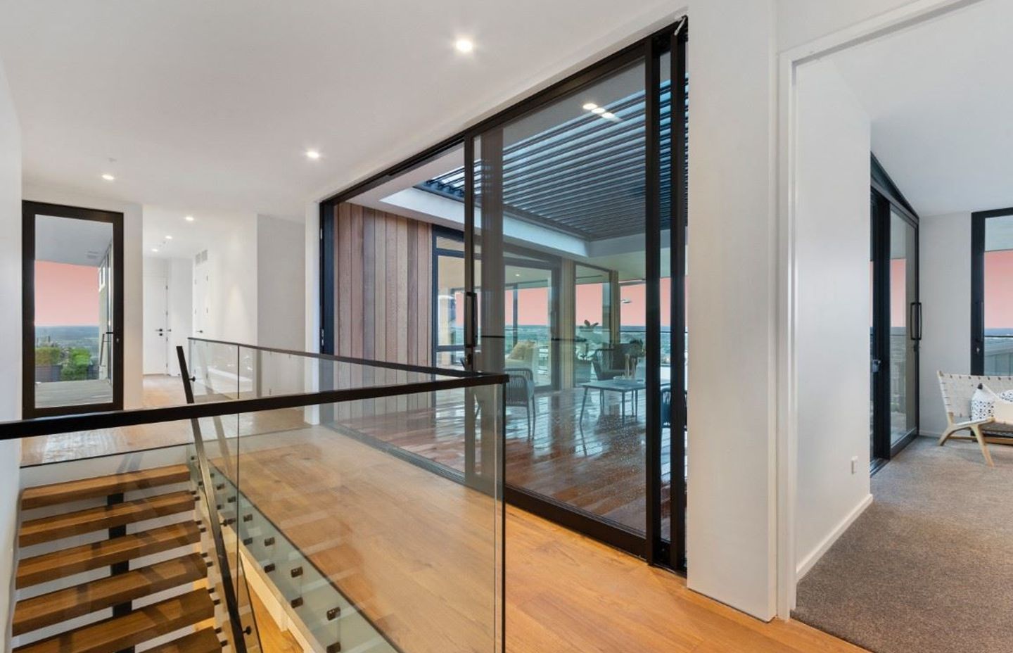 The frameless glass balustrade on this staircase helps the space feel bright and open.