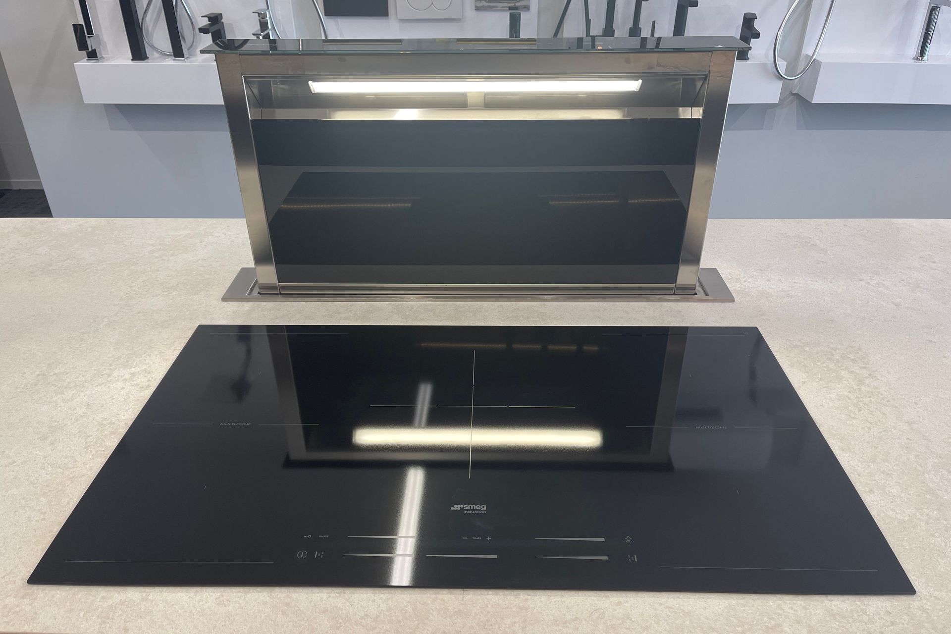 When you need to use the downdraft range hood, you simply press a button and it comes up.