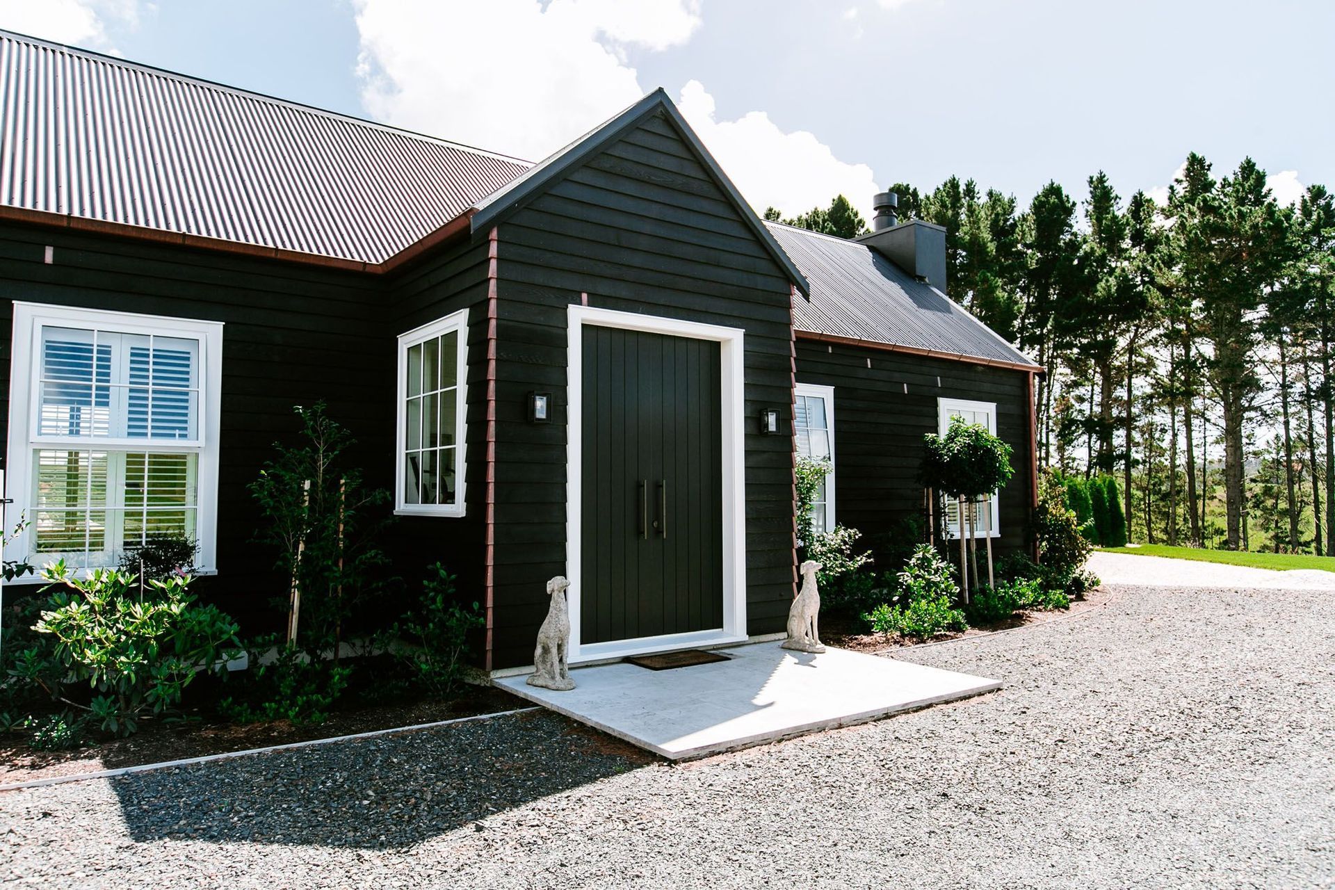 A bold white against black frame makes for a strong entrance to this exquisite Duck Creek home