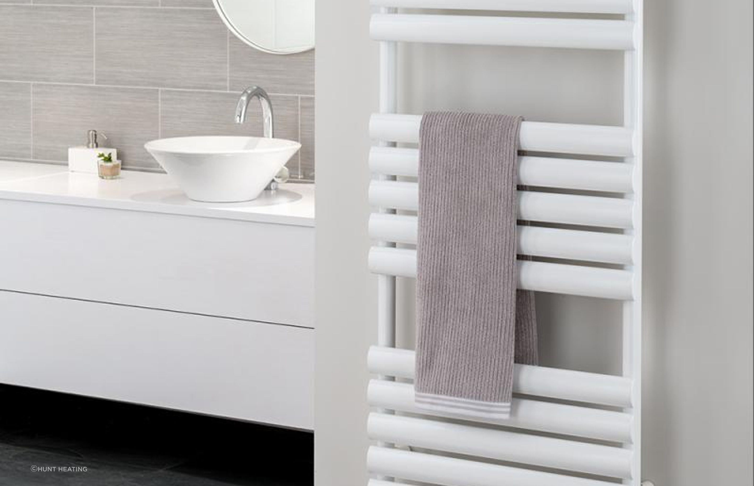 A small towel stays warm on a Ellipsis Towel Rail Heated Towel Rails from Hunt Heating
