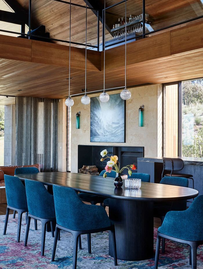 Stylish wall art, modern pendant lights and a contemporary dining table bring the living space to life. Photographer: Shannon McGrath