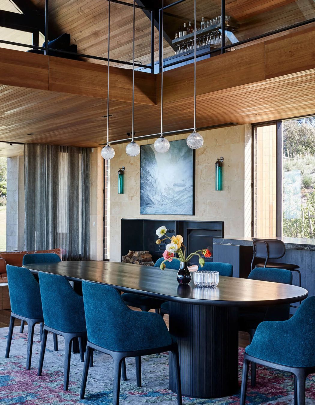 Stylish wall art, modern pendant lights and a contemporary dining table bring the living space to life. Photographer: Shannon McGrath