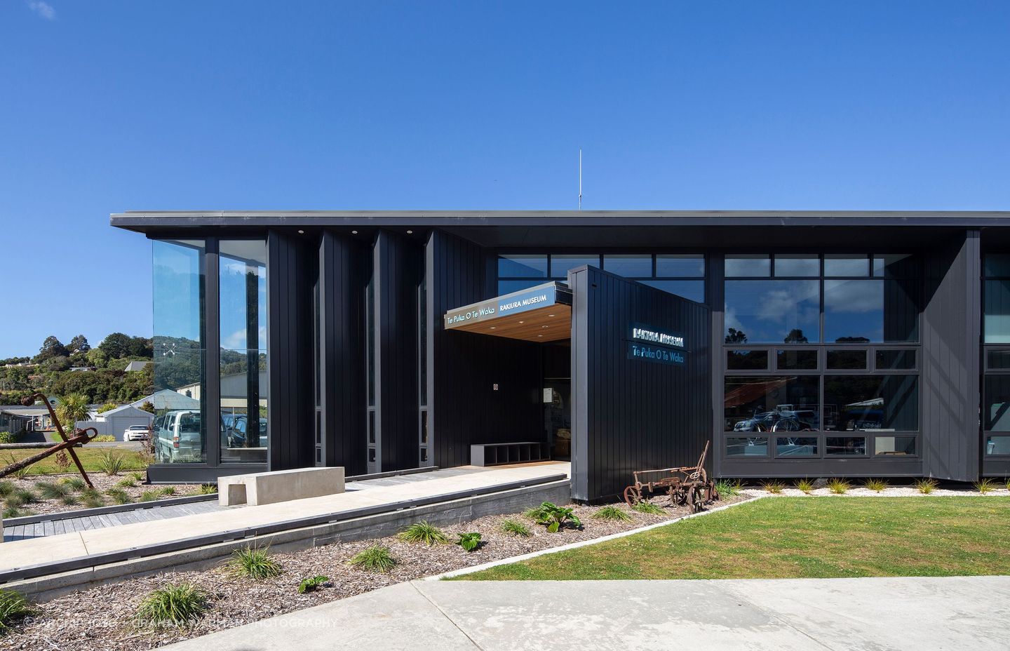 The exterior material palette is predominantly dark painted timber panels, which was all moved into place by hand.