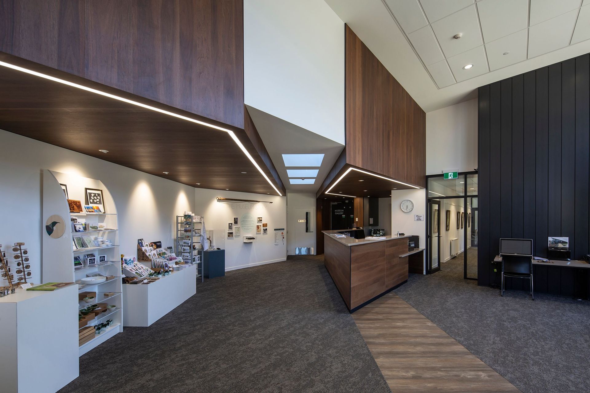 The entry foyer is filled with light; the corridor to the right of the reception desk leads to the offices and cafeteria, while to the left are the museum galleries.