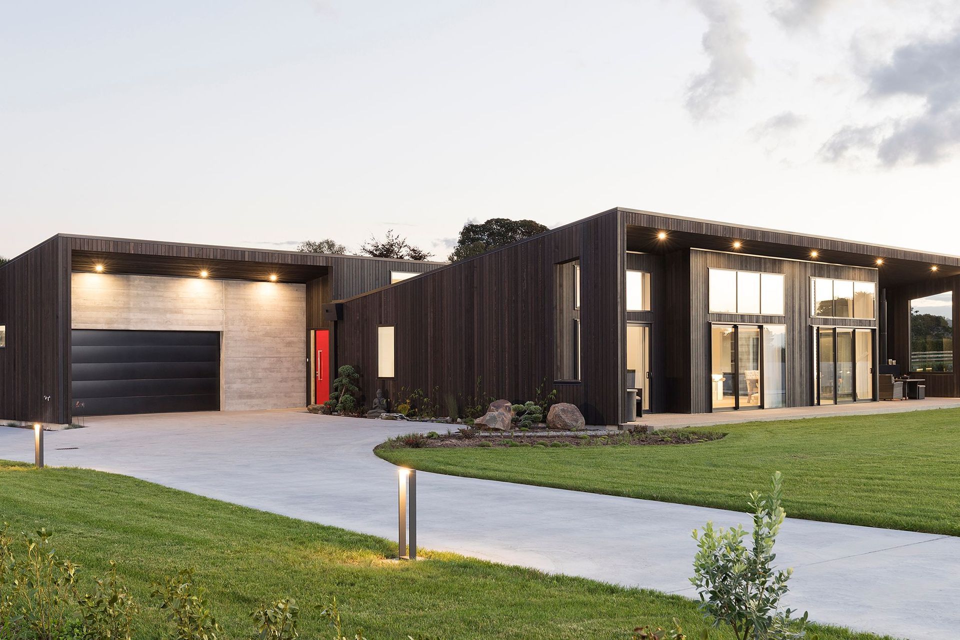 Dark stained weatherboards create a striking scene with this contemporary Tauranga home
