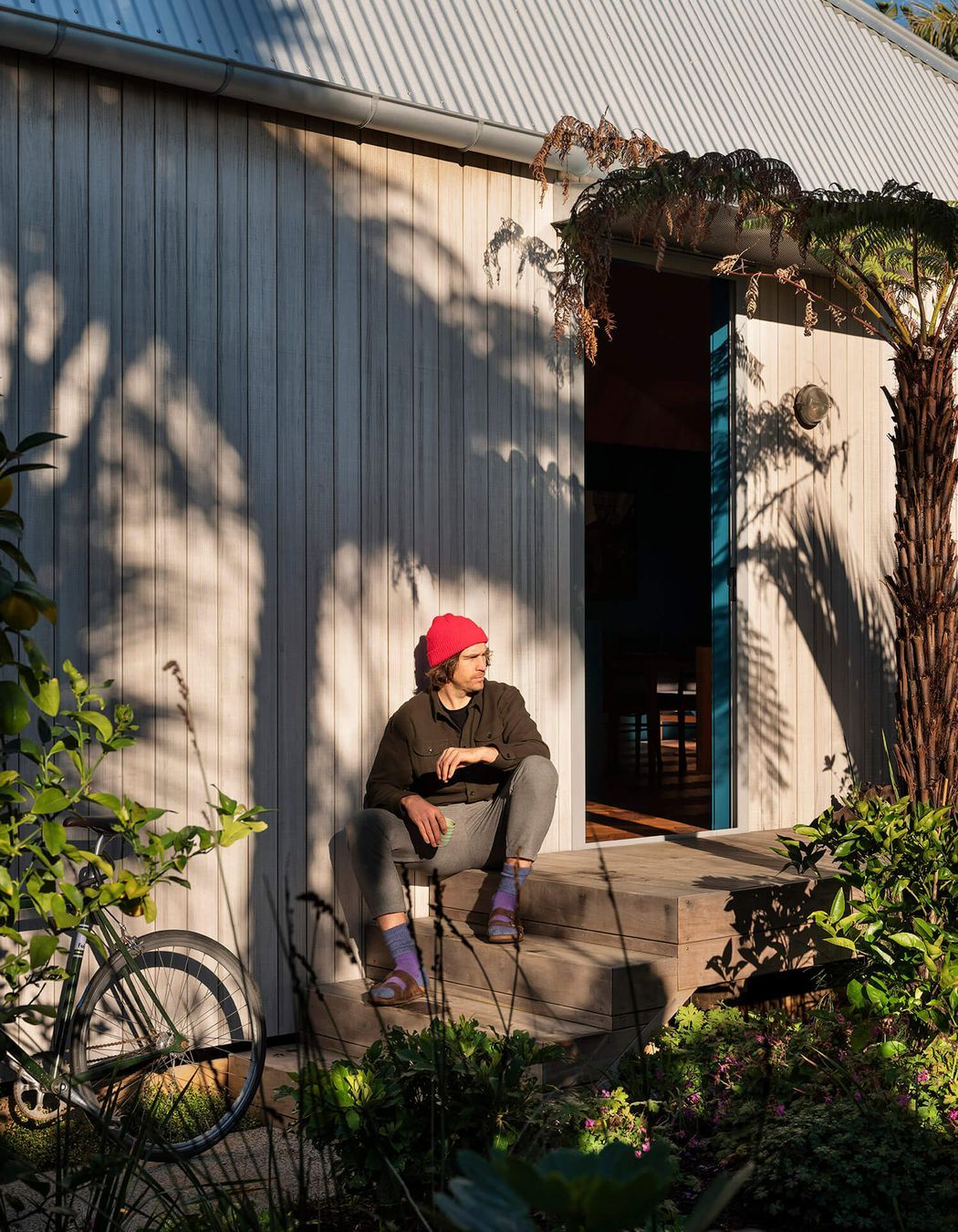 The silvered exterior — achieved using Abodo Vulcan Sioo cladding — makes way for a playful palette indoors.