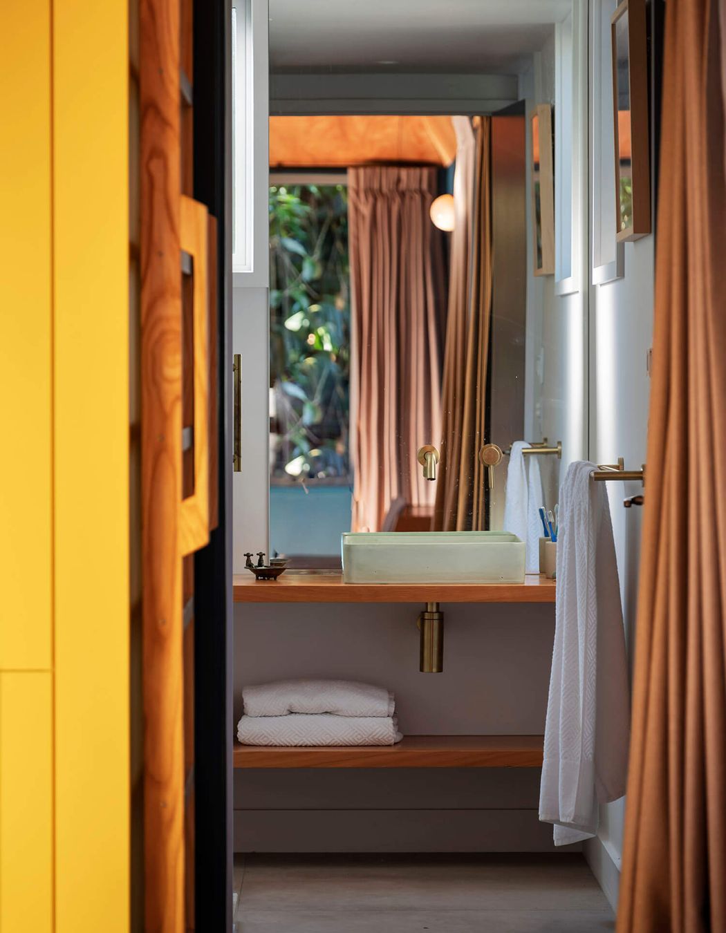 The bathroom is neatly tucked below the mezzanine.