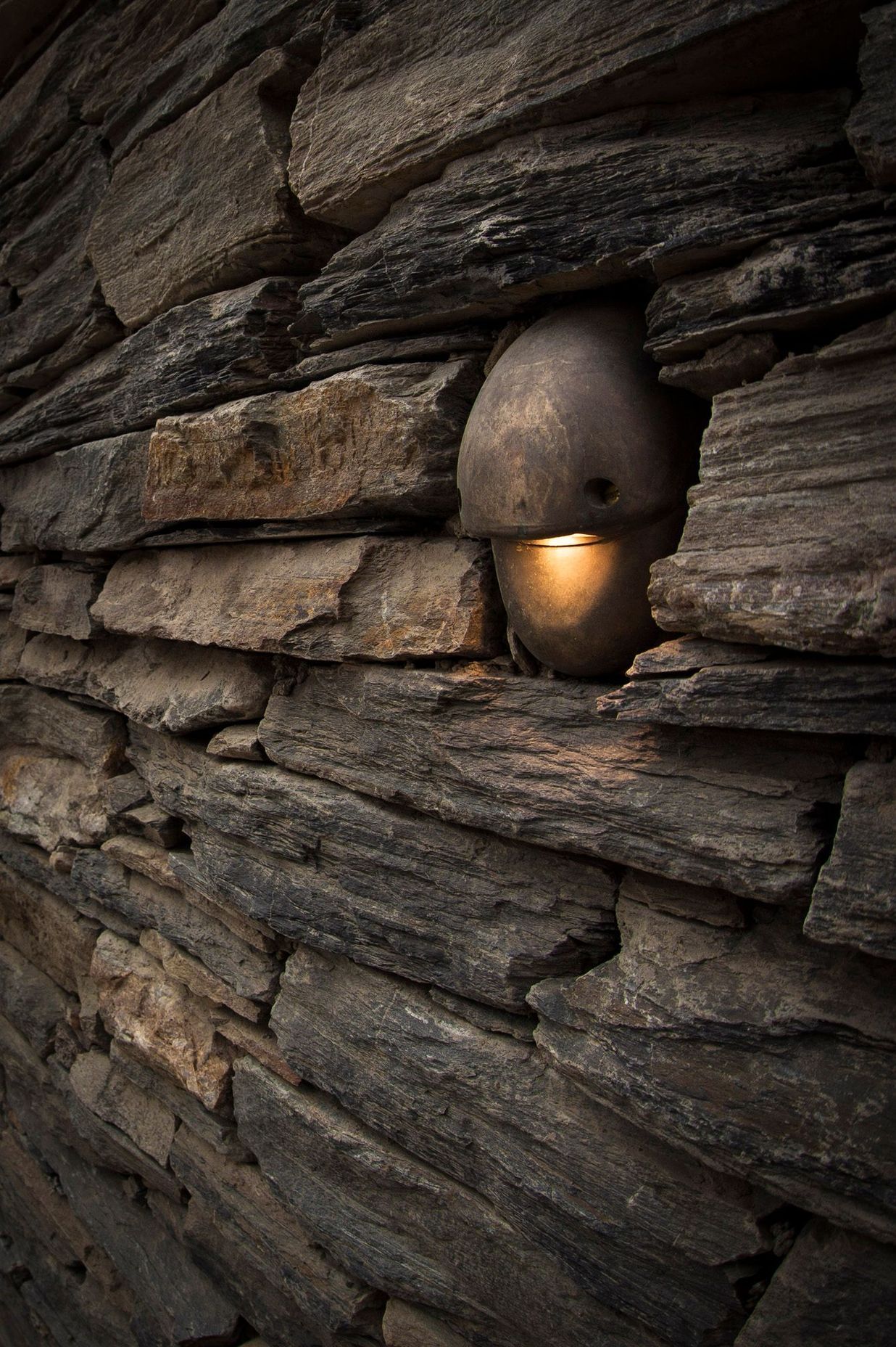 The Hunza Mouse Outdoor Wall Light blends unobtrusively into outdoor environments.