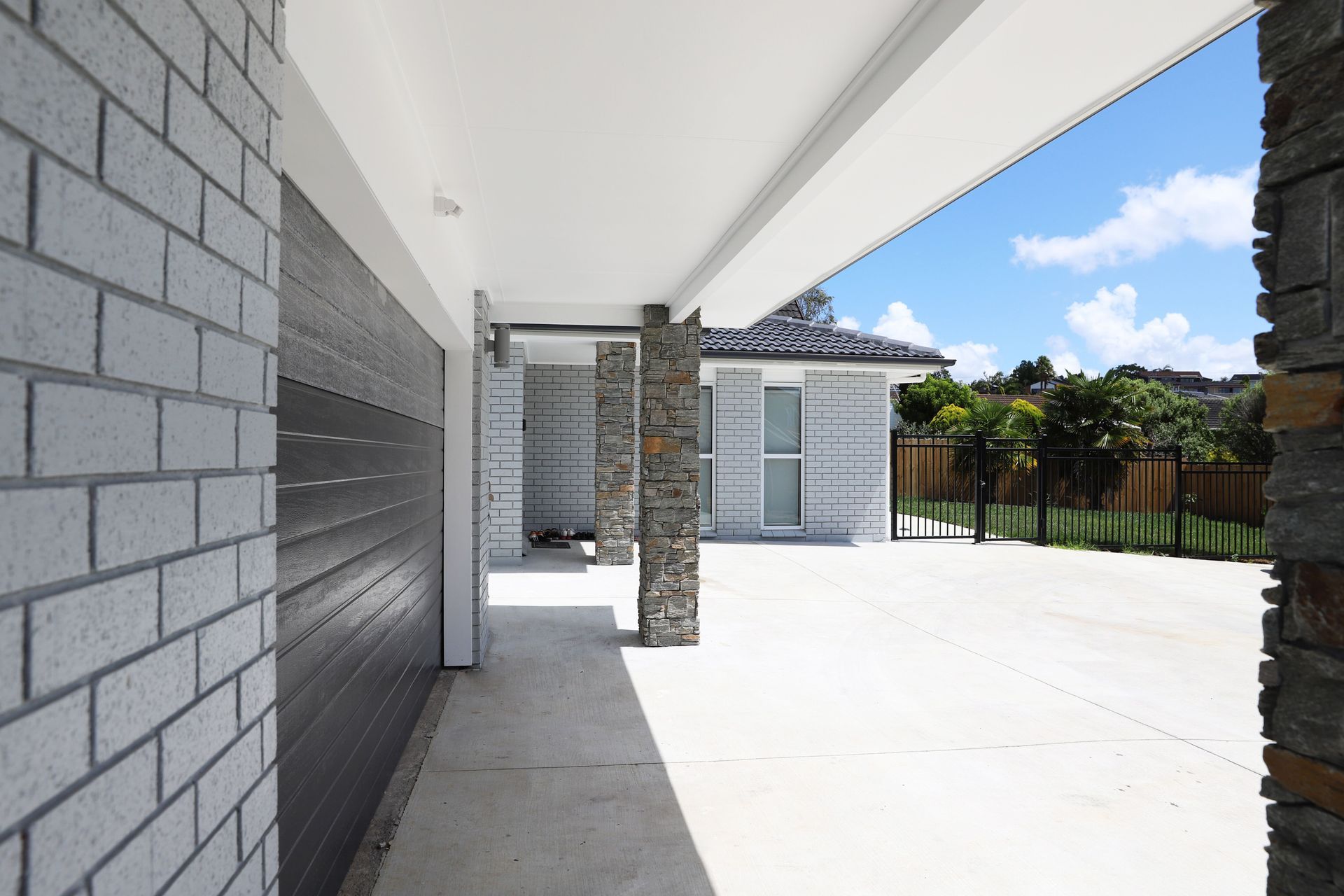 Concrete Driveway and a fenced side garden in this landscaping project in West Harbour, Auckland