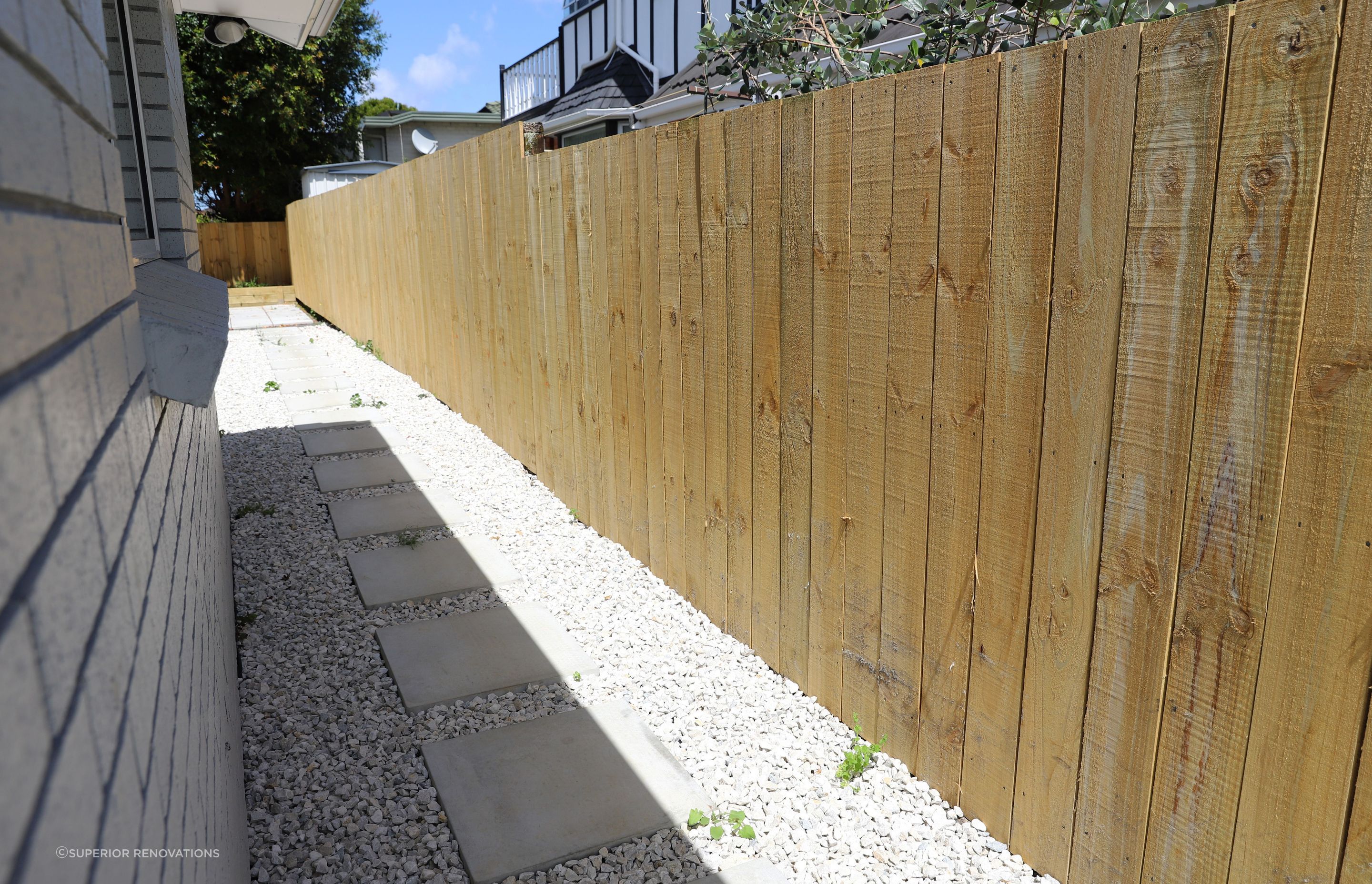 We created pathways around the house to get from one section of the exterior to another. This pathway leads from the front garden to the back of the house where we created a vegetable garden and patio