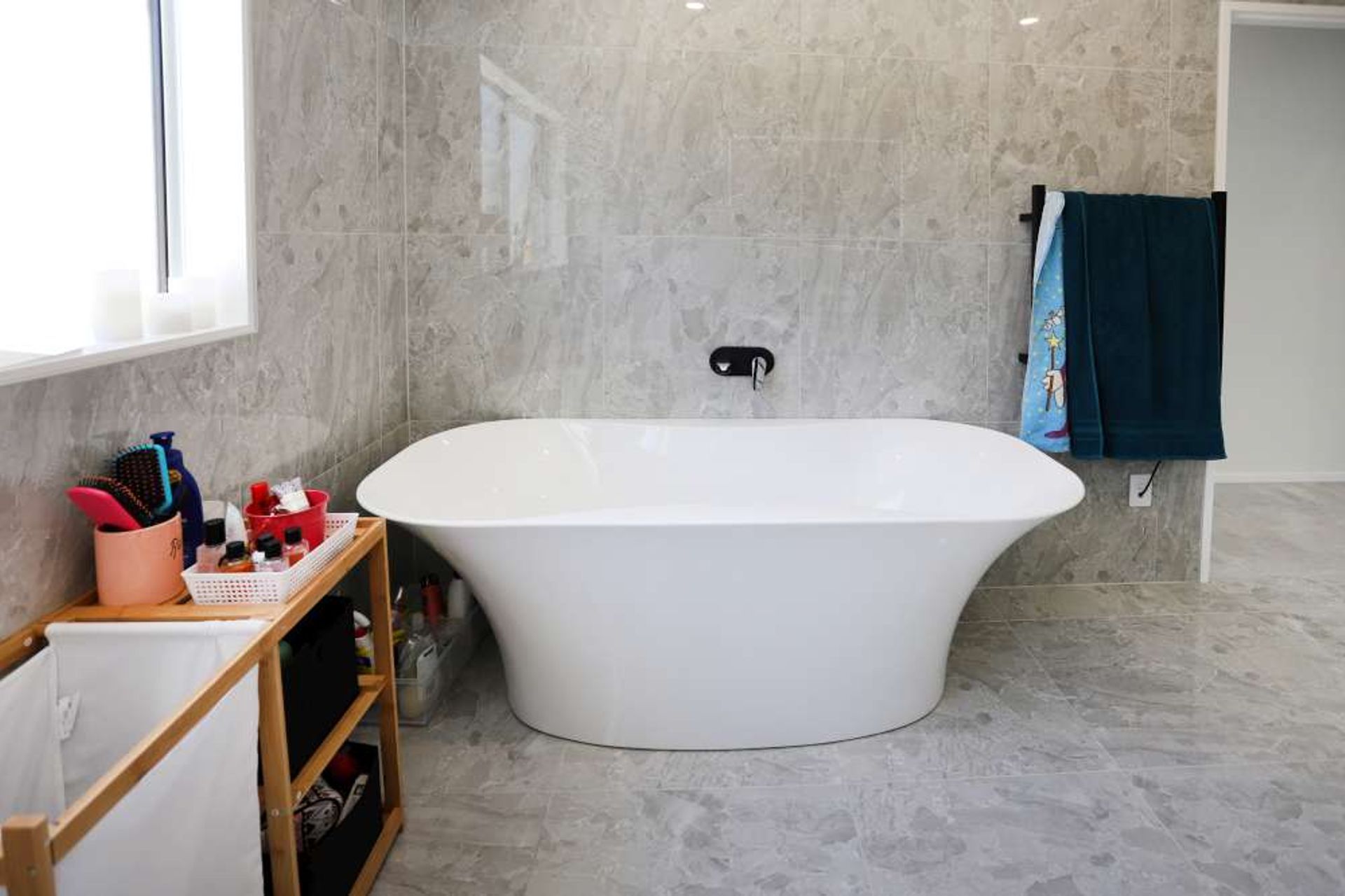 standing bathtub was incorporated in this ensuite in this bathroom renovation in West Harbour