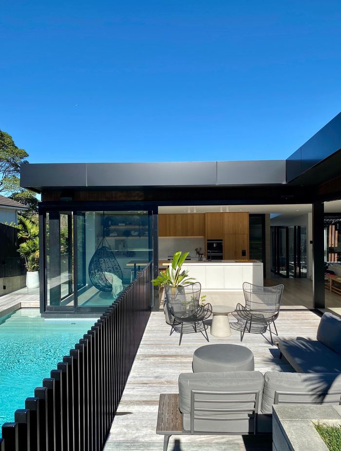 Extensive glazing opens out from the kitchen and living onto the deck and pool area.