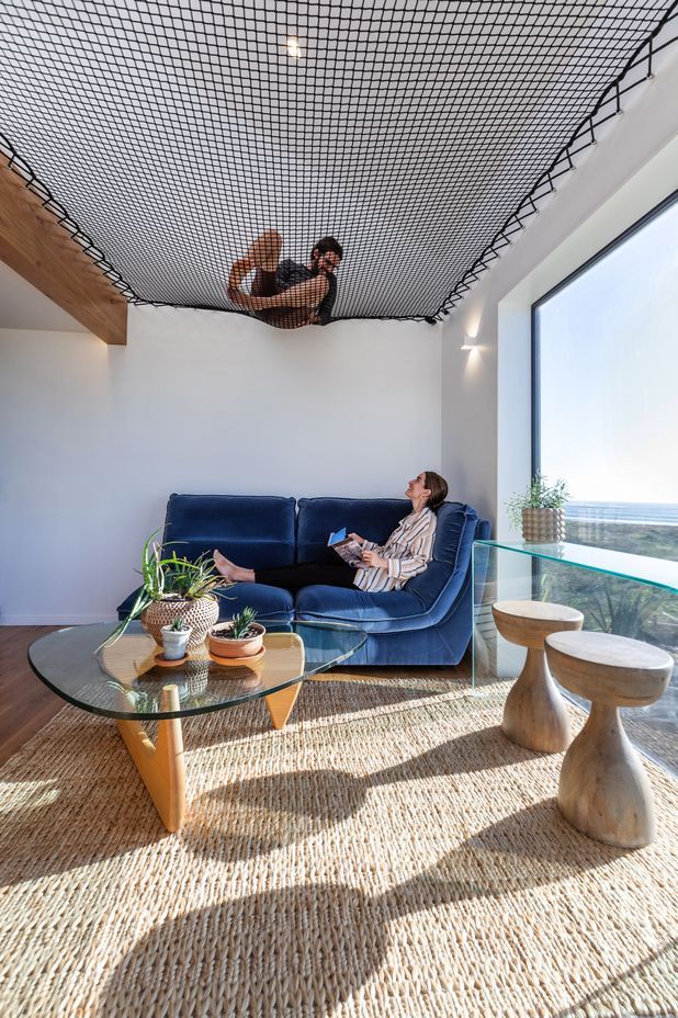 Homeowners Matthieu and Maria, lounging in the smaller pod. | Photographer: Sandra Henderson