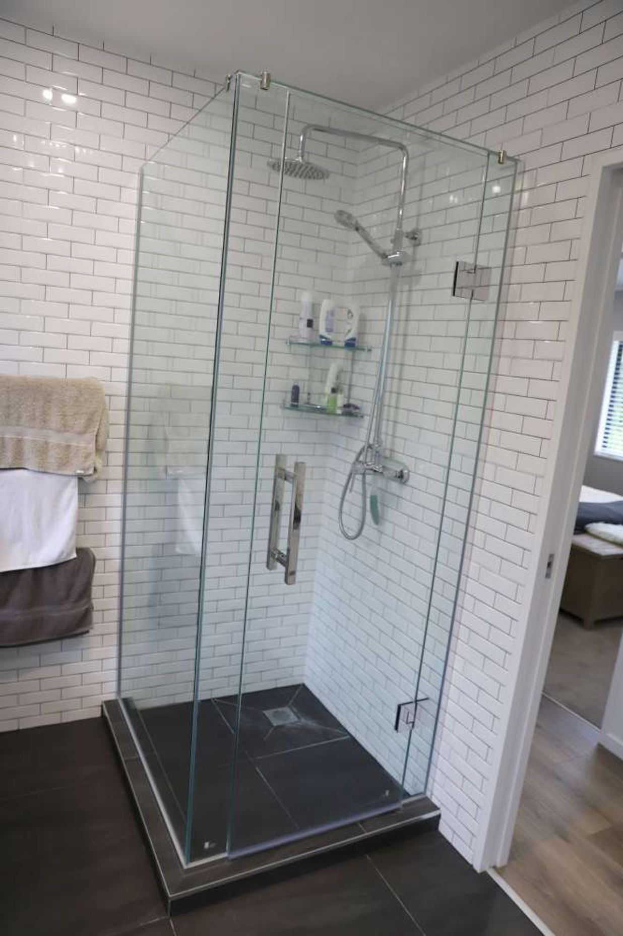 The installation of a pocket door enabled us to create this shower on the left side of the door.