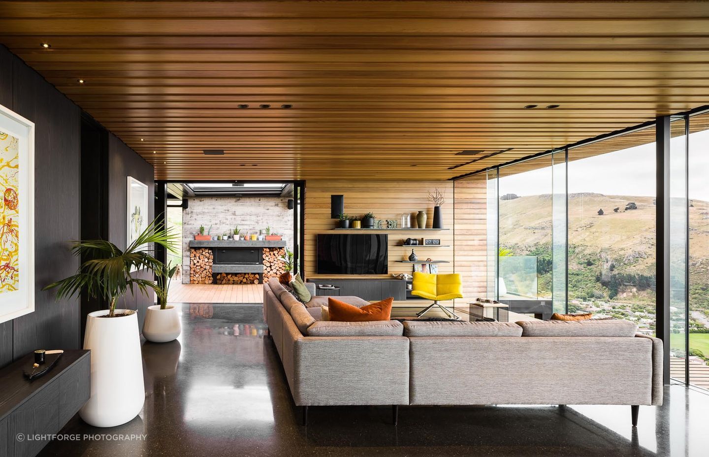 The open-plan living space leads directly to the outdoor living space through floor-to-ceiling sliders.