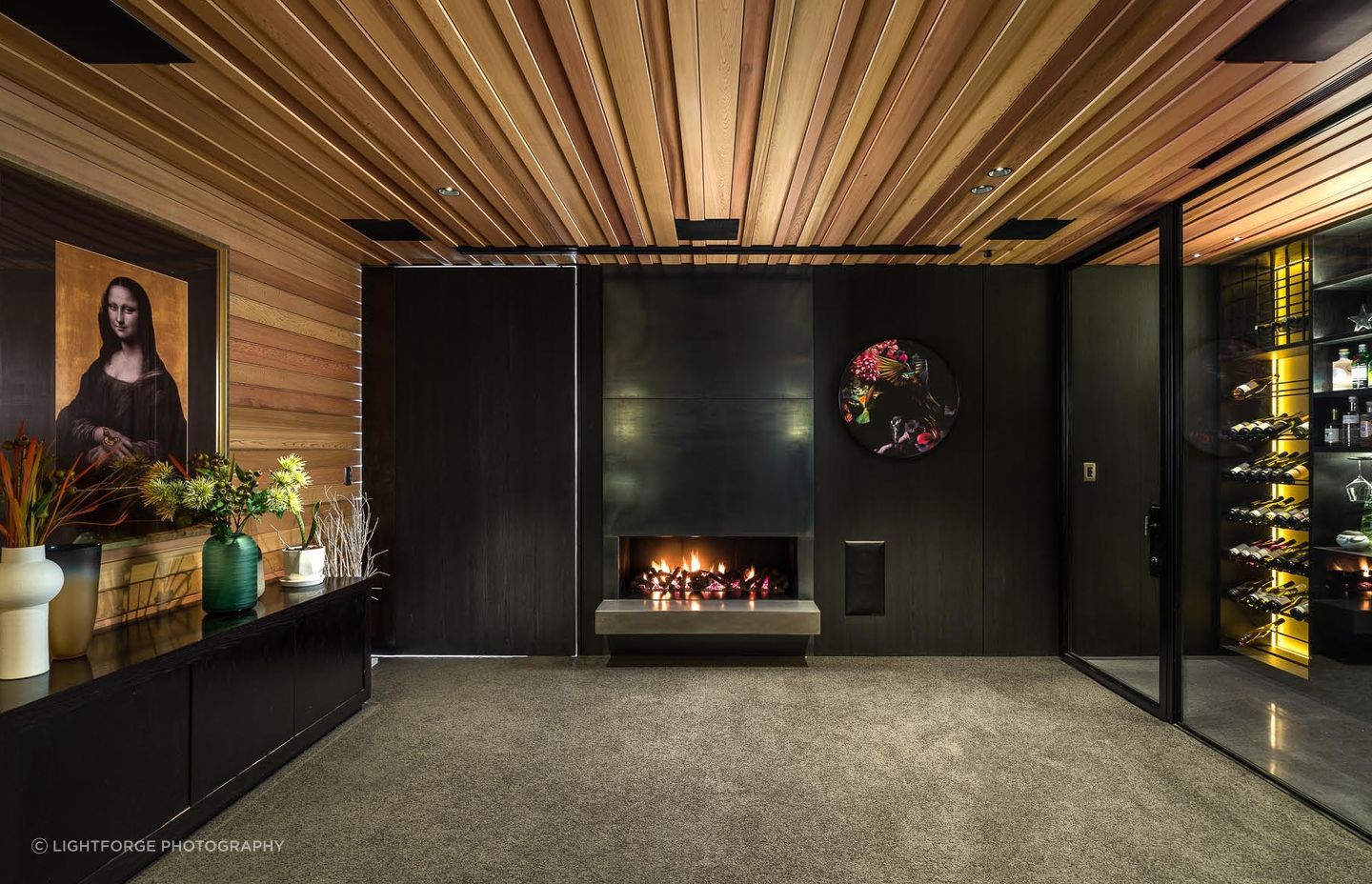 This TV lounge tucks in to the back of the living space and features a state-of-the-art wine storage system on one wall.