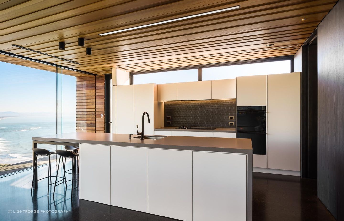 A monochromatic colour palette in the kitchen allows the view to take centre stage.