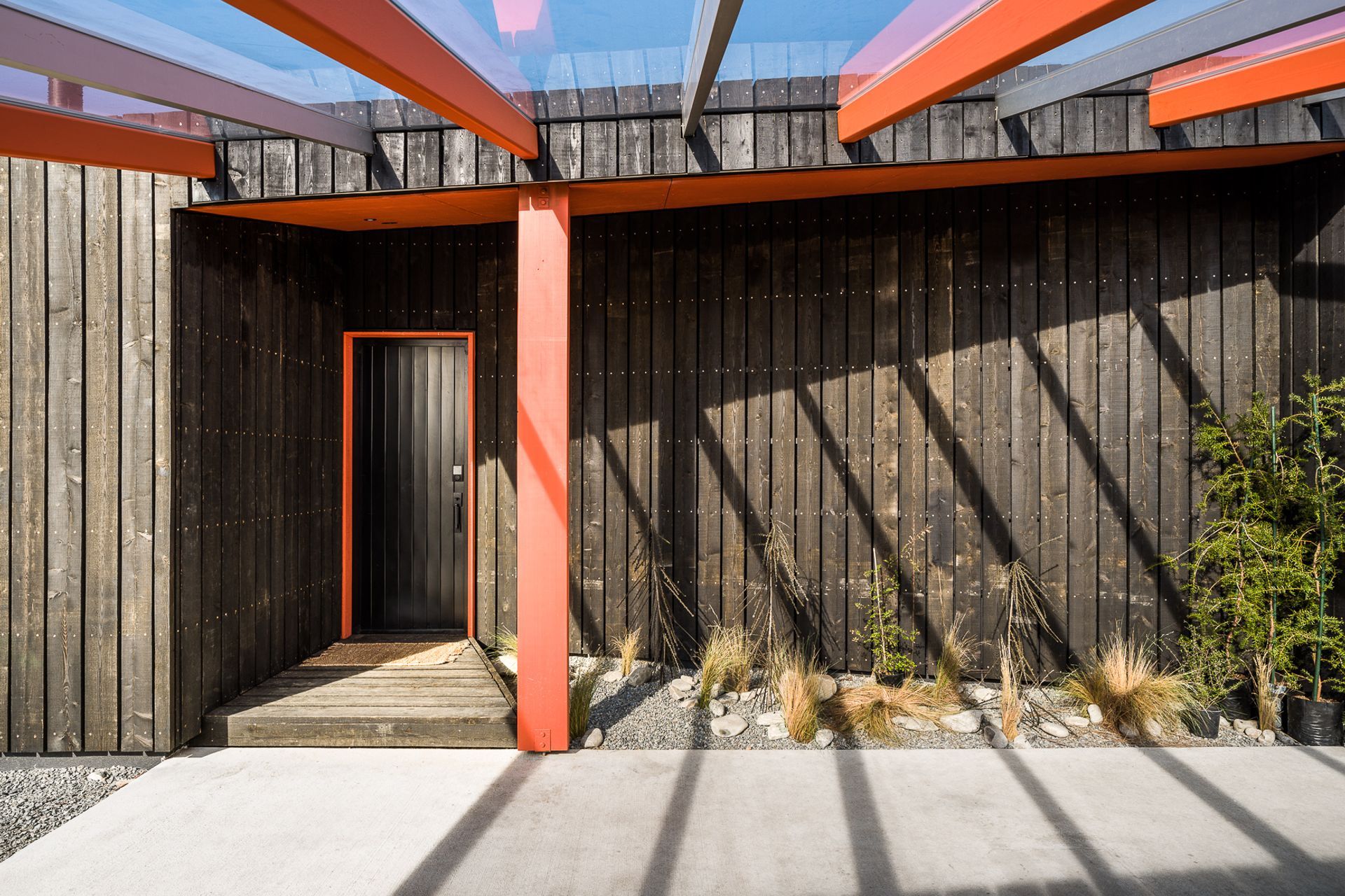 The entry door of Skylark Cabin in the Ben Ohau Range features a cohesive colour scheme with architectural elements of the home - Photography:  Lightforge Photography