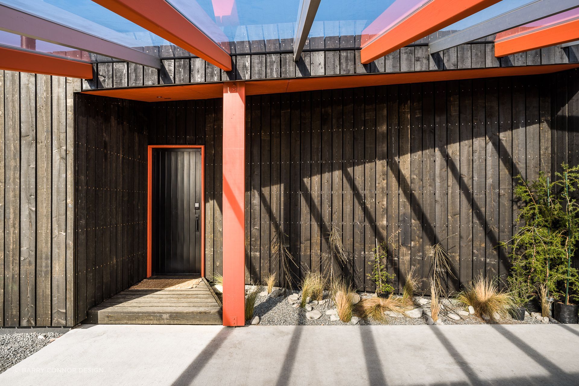 The entry door of Skylark Cabin in the Ben Ohau Range features a cohesive colour scheme with architectural elements of the home - Photography:  Lightforge Photography