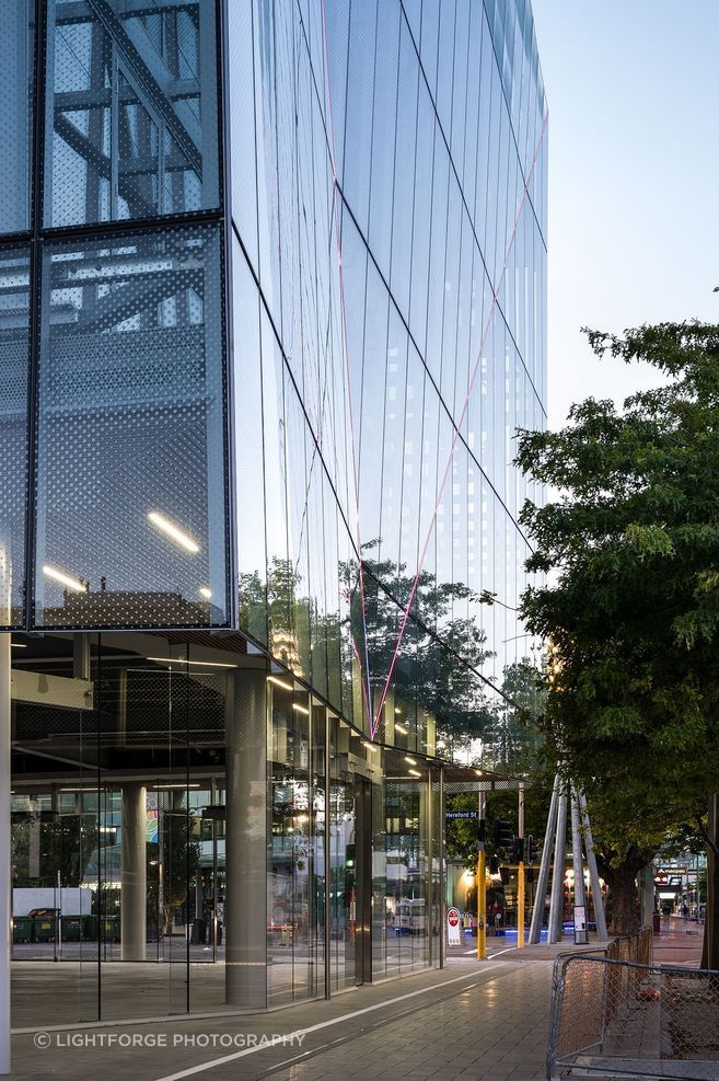 A close-up view shows the twin-skinned facade hanging like a curtain over the walkway and the fritting on the glass panels. Photograph: Dennis Radermacher/Lightforge.