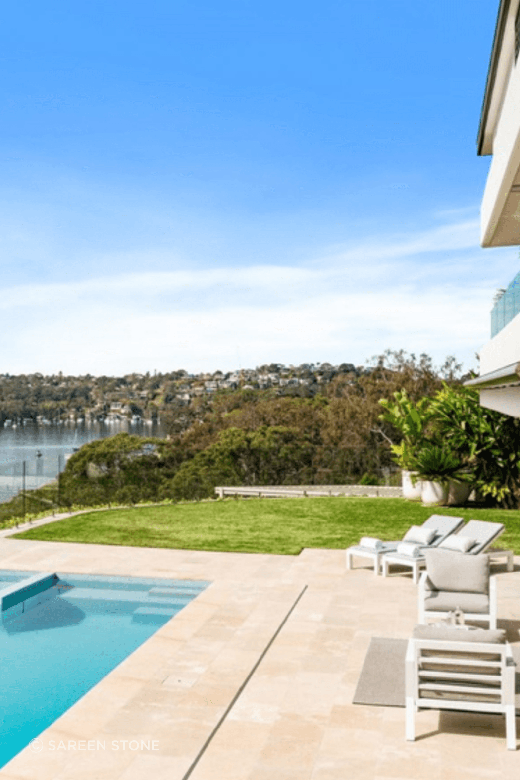 Lavarosa Limestone pool surrounds at Castle Cove, where warm natural stone meets an uninterrupted waterway view.
