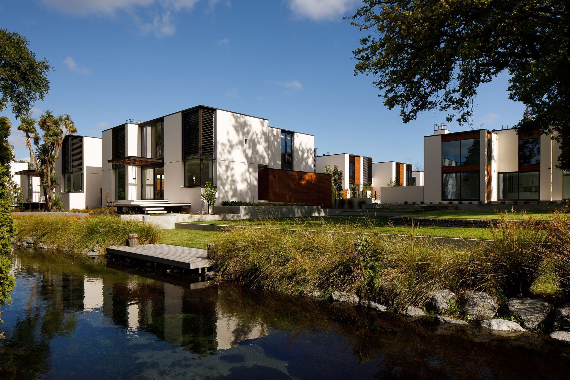 A community-minded housing development in Christchurch, Lintrathen Gardens by Sheppard & Rout Architects hosts ten townhouses connected to a shared riverside green of the Avon River. Photograph by Jason Mann.