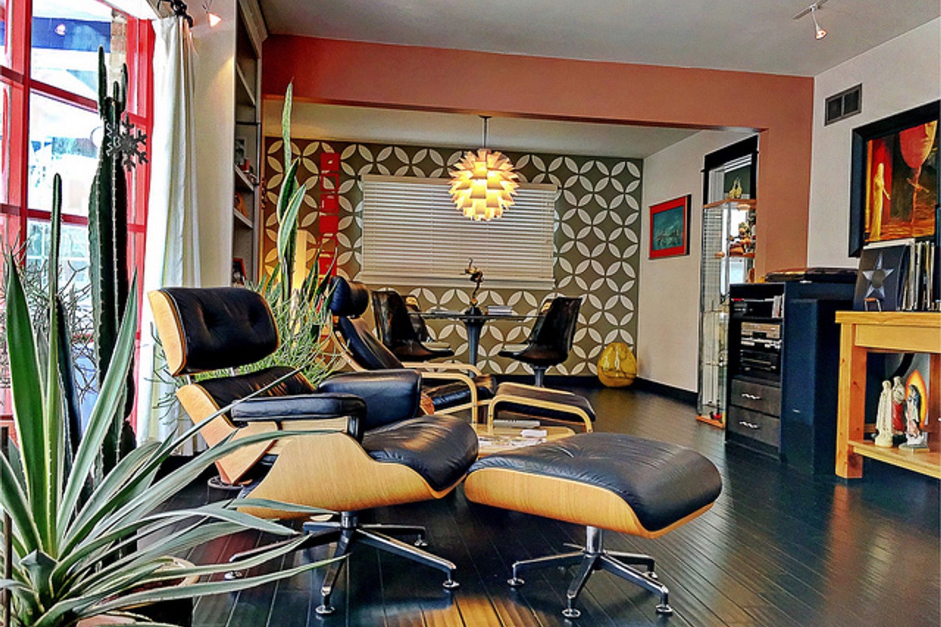 Bold prints, pops of colour and the iconic Eames chair give this space its mid-century mode