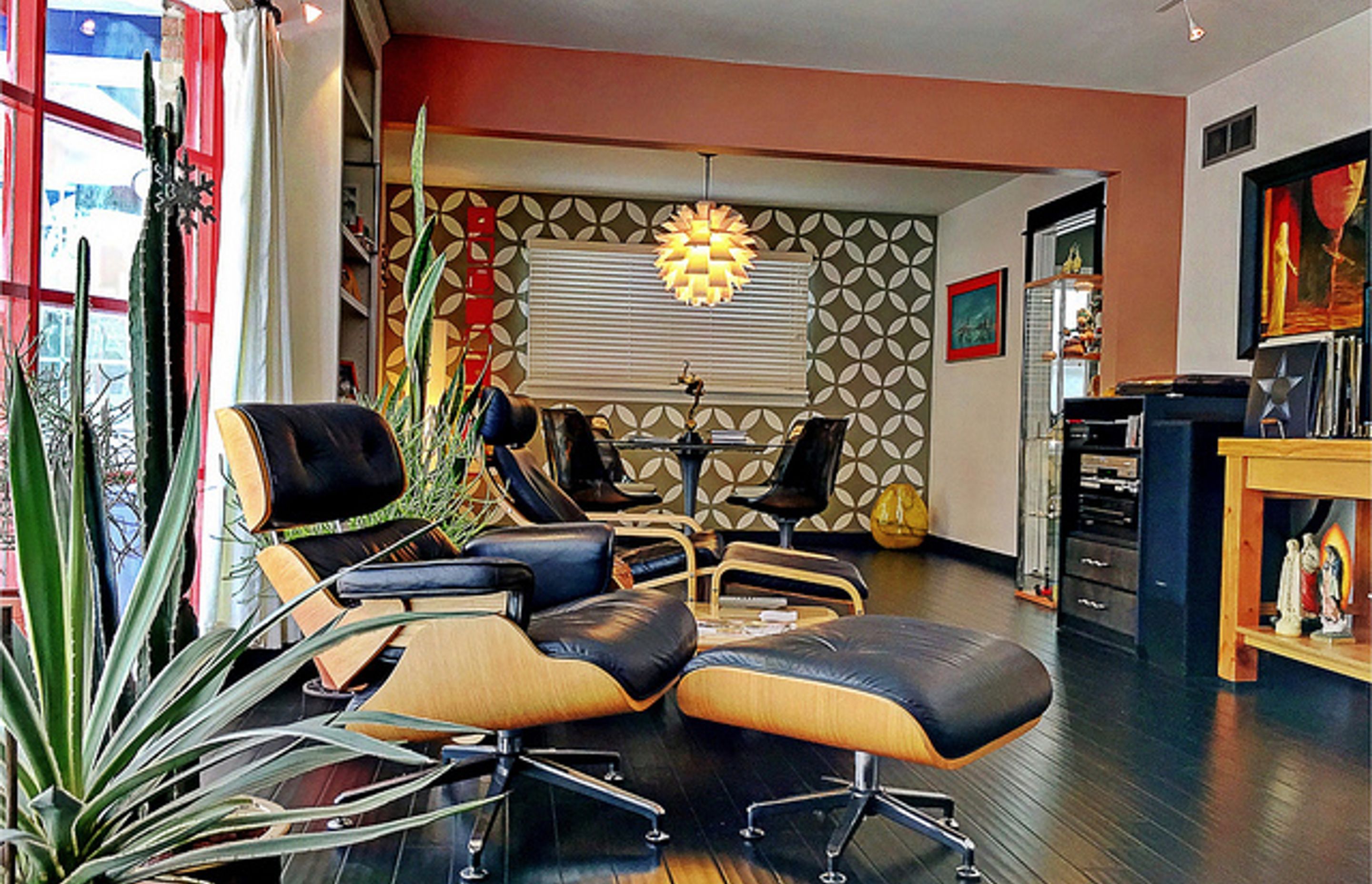 Bold prints, pops of colour and the iconic Eames chair give this space its mid-century mode