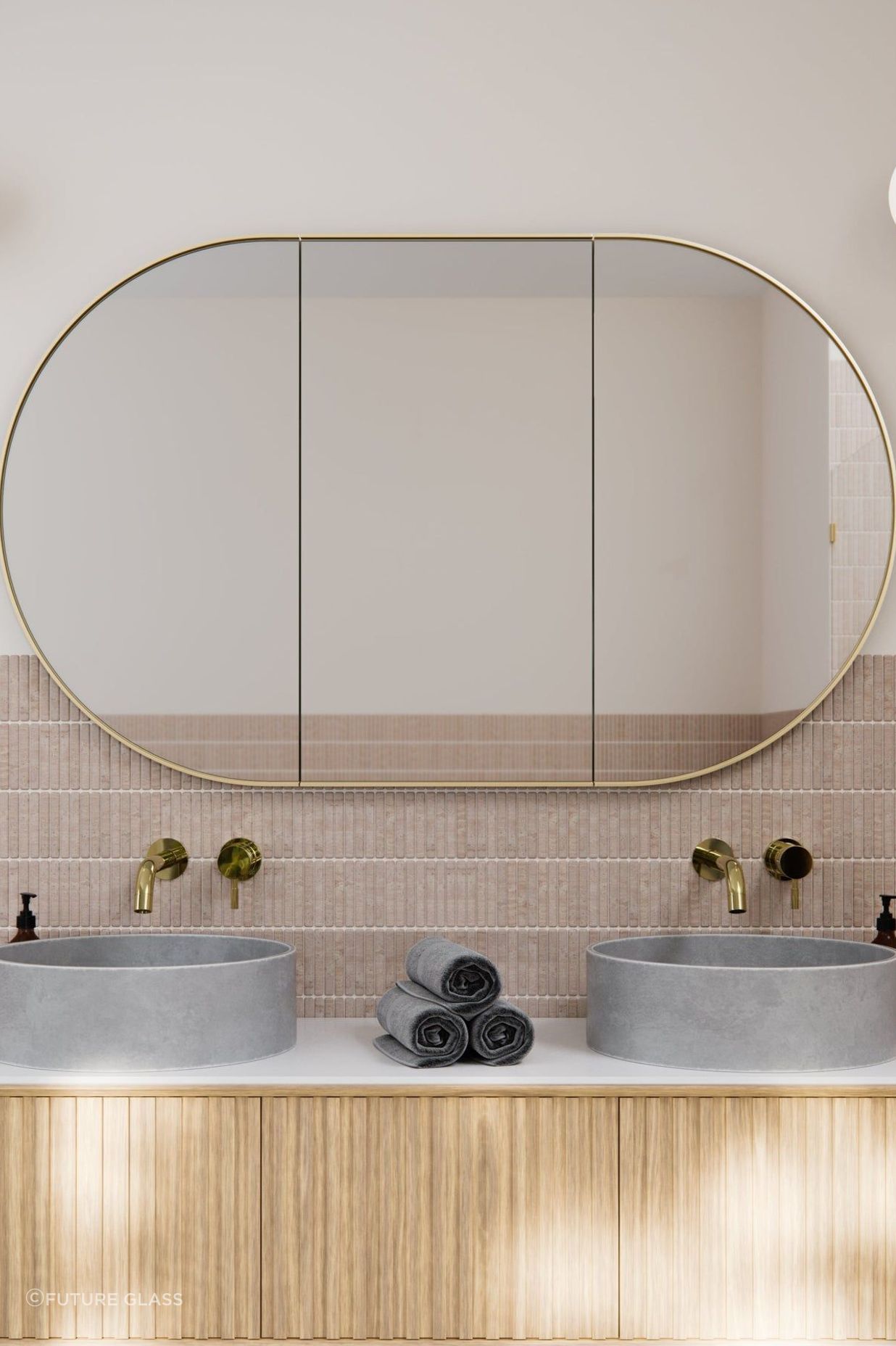 The brass satin frame matches the material of the taps. Featured product: Pill Mirror Cabinet