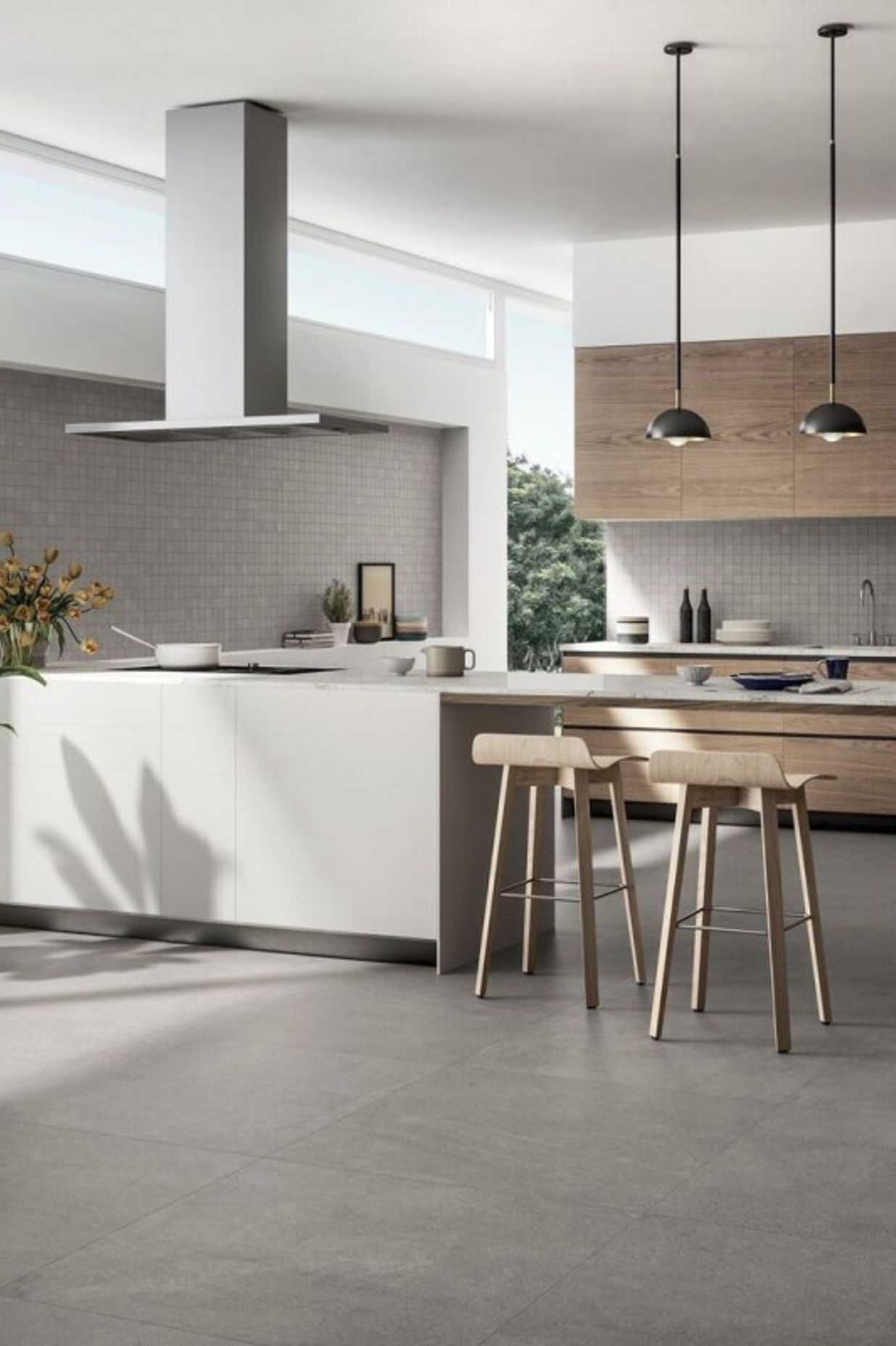 As seen in the picture, this kitchen flooring features large slabs of square tiles where the grouting is matched with the colour of the tile. This give the floor a a sort of continuity as the grout lines are hardly visible. (Tile Depot 2021)