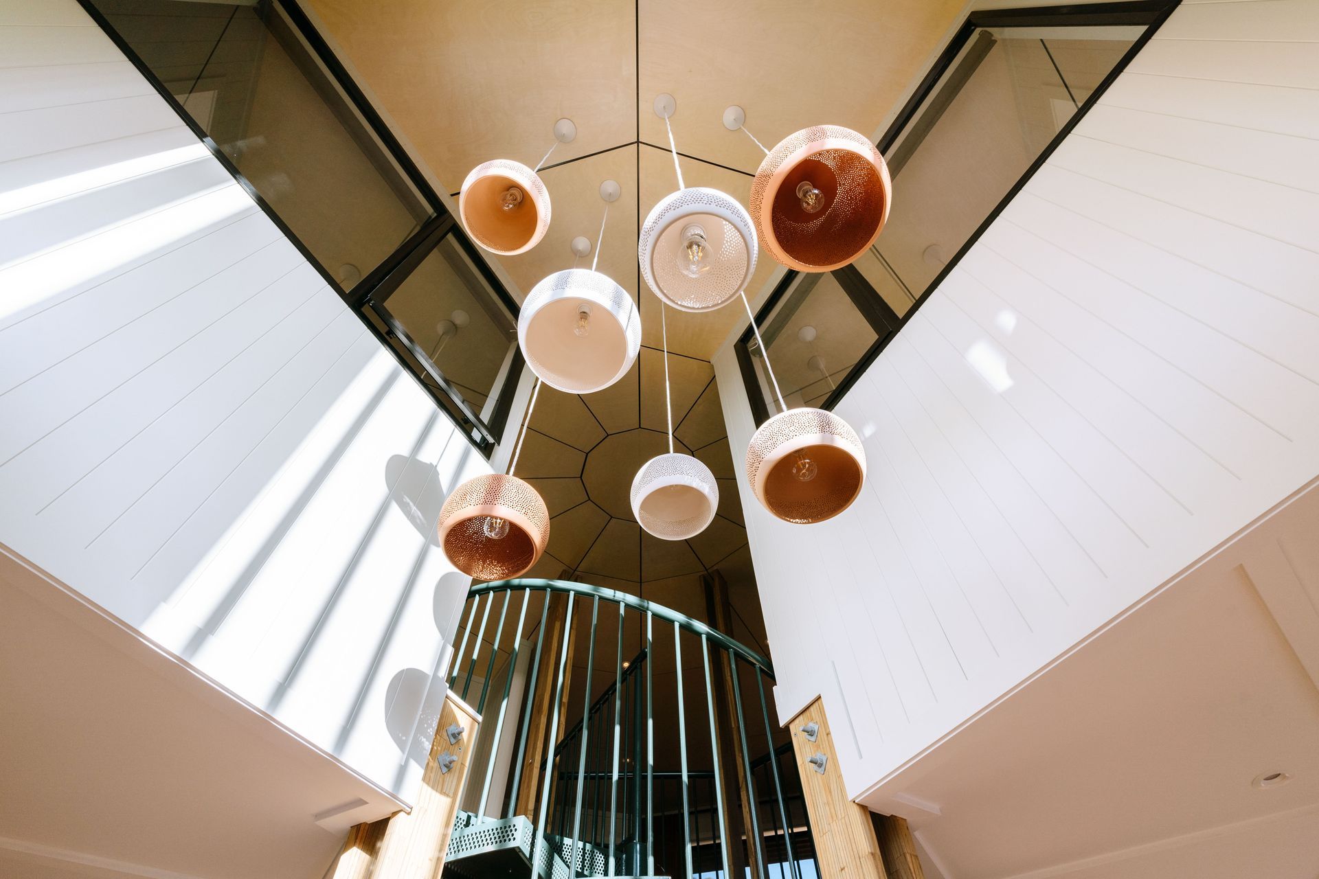 Feature lighting hangs above the main entrance, drawing your eyes to the upper level.