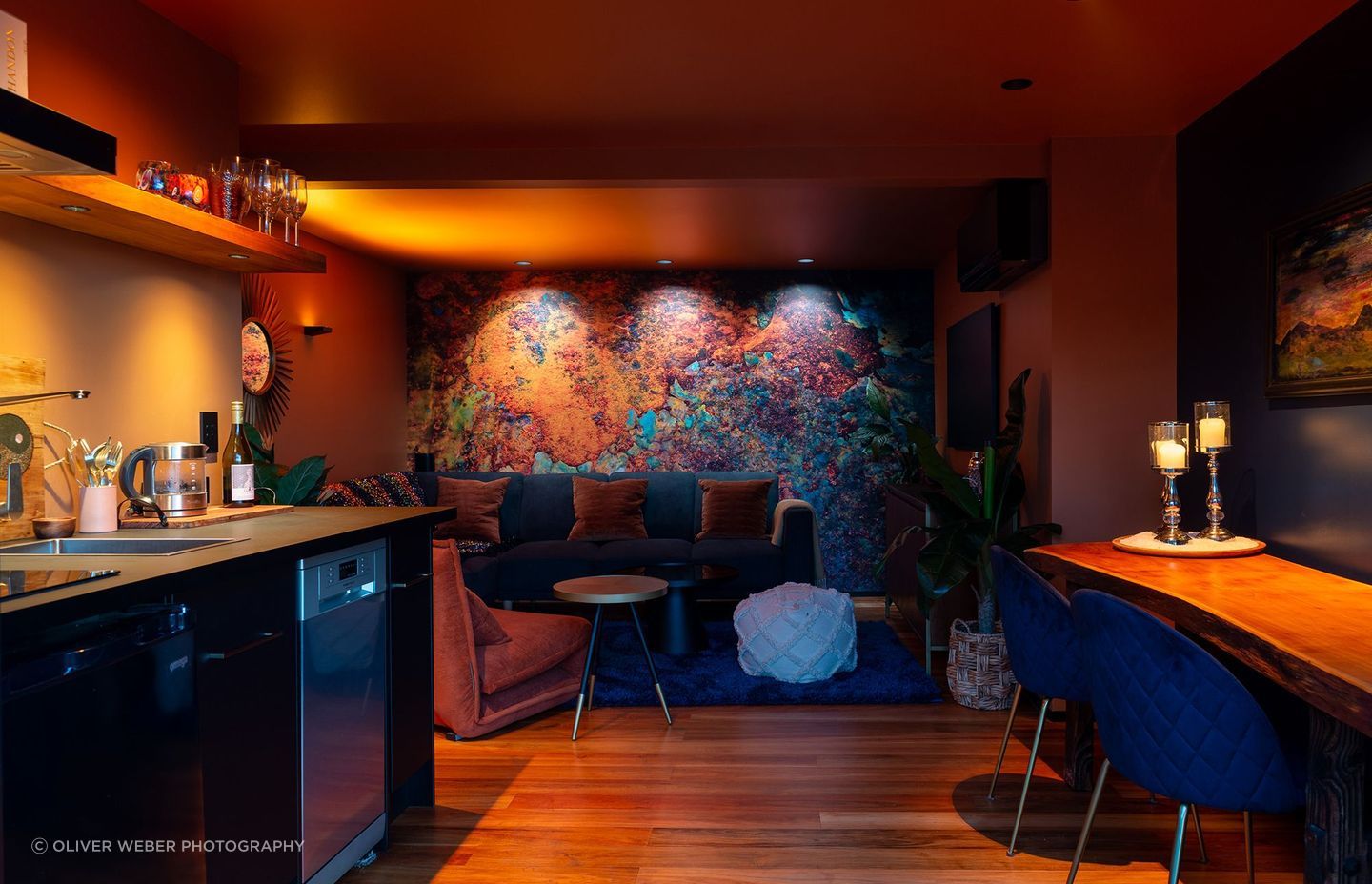 Abstract mural wall, illuminated with a variety of colour temperatures to highlight different colour ranges in the artwork, ranging from 1800K on the left, to 3000K in the centre, and finally 4000k on the right. Product: Switch Lighting ZELA Offset Deep Tilt SLDL251T