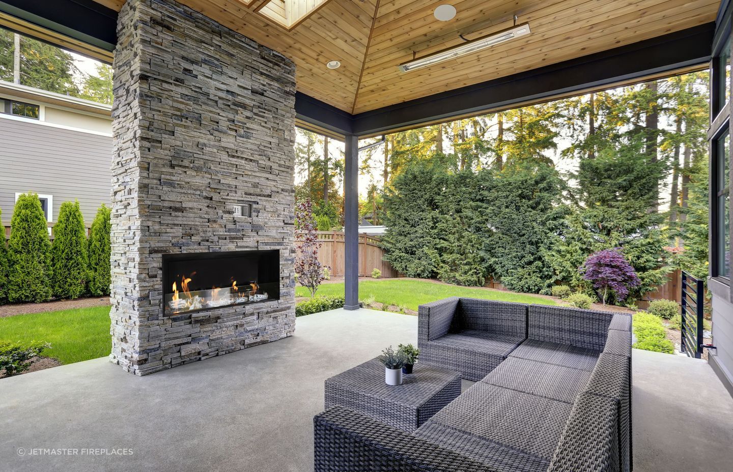Complete an outdoor room with a fireplace that seamlessly fits with the existing design