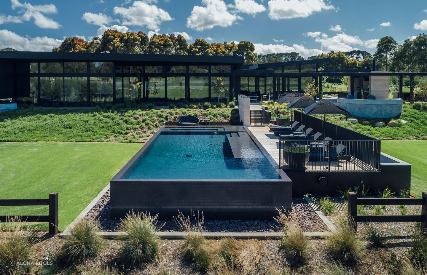 The deck fencing protects the deck and pool while keeping both private. Featured project: Perry Luxury Pool.