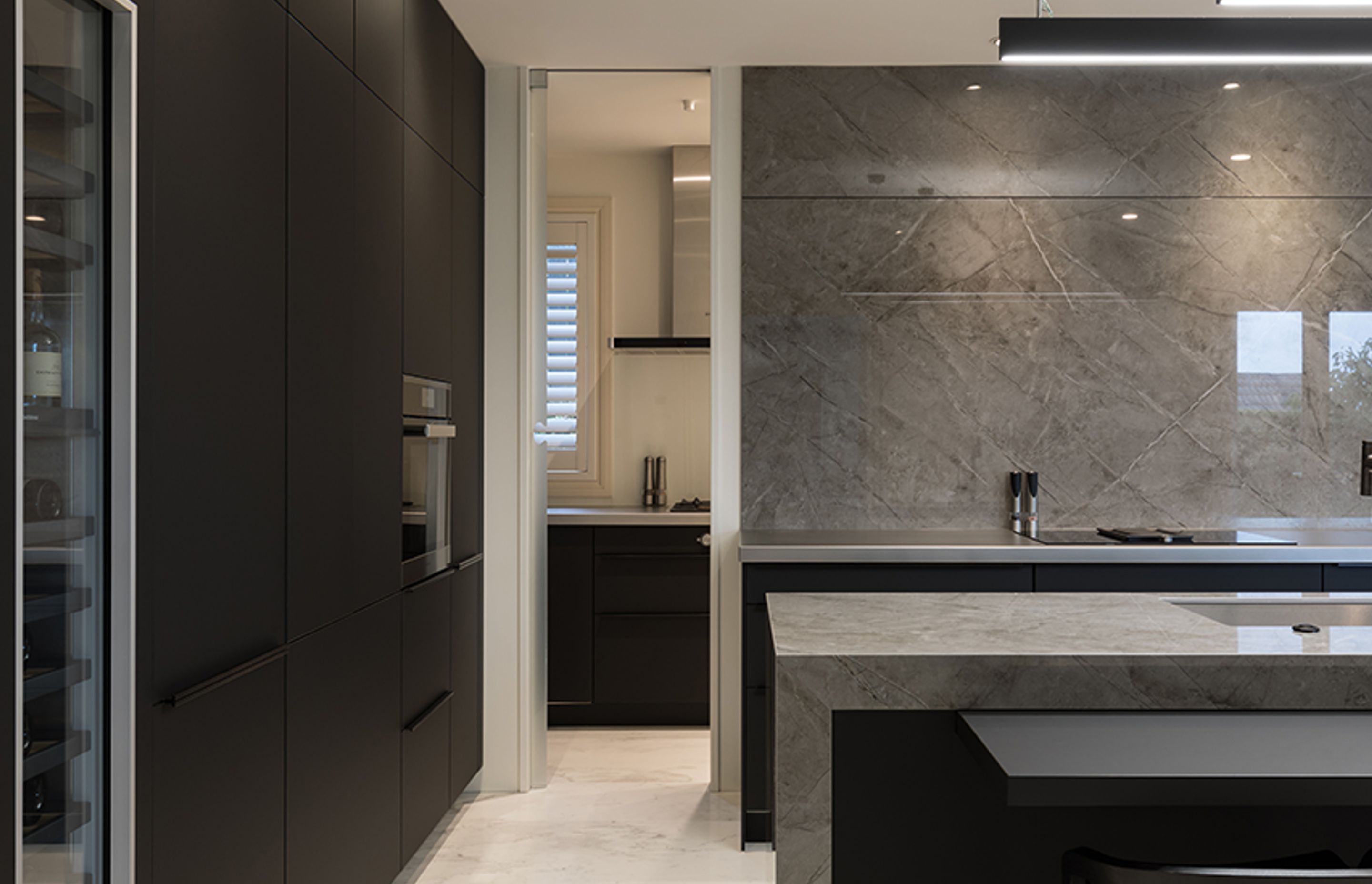Tone-on-tone surfaces impart a sleek, sophisticated feel to the kitchen space, while the inclusion of a scullery means all the day-to-day minutiae is hidden behind doors.