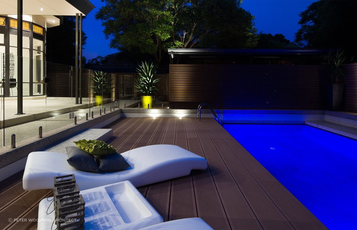 The wooden fencing to the right-hand side of the pool protects the far side, while a frameless glass fence protects the deck. Featured project: The Pool Deck Unley.